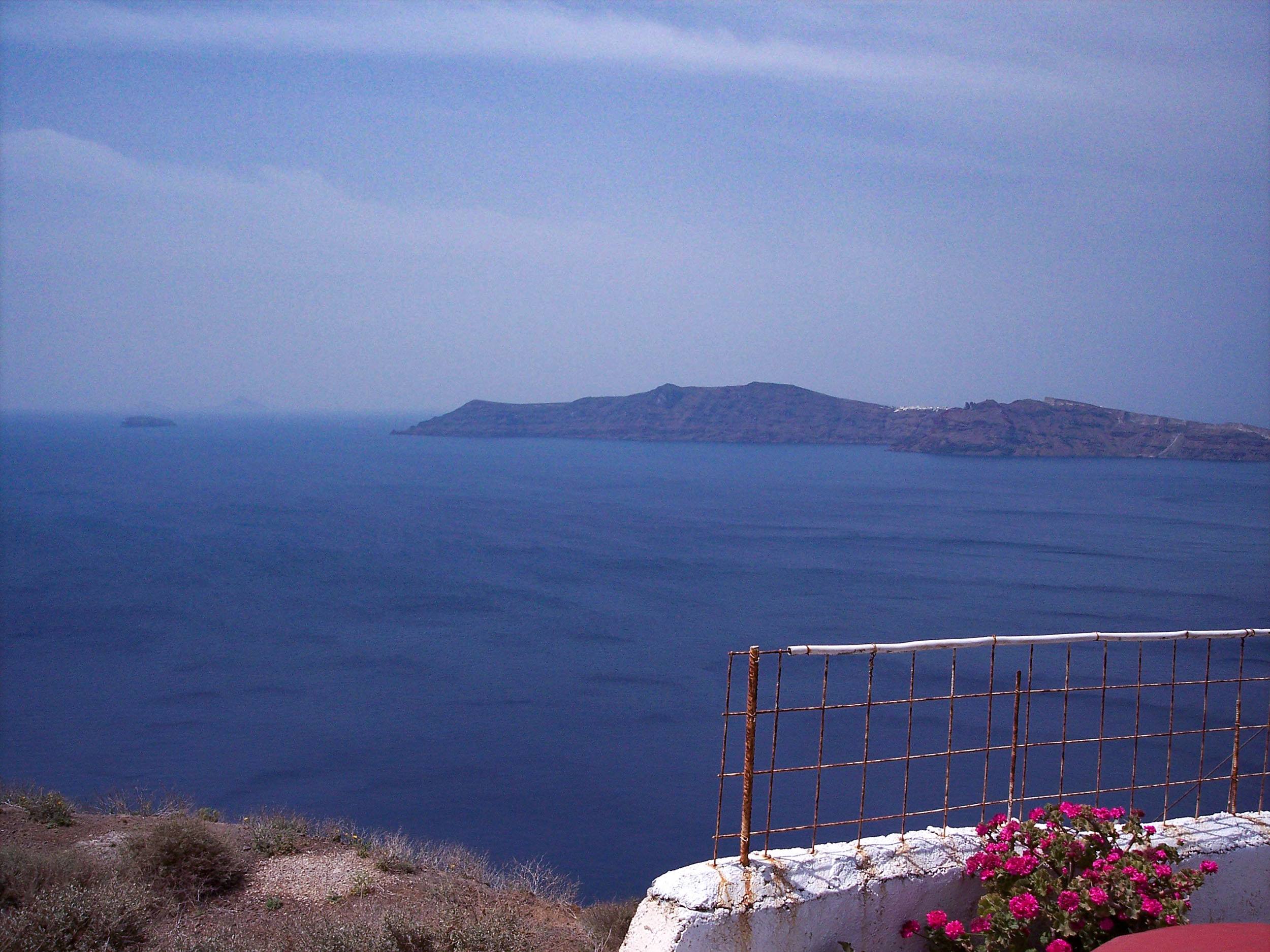 Flowers on balcony overlooking sea in Santorini Greece