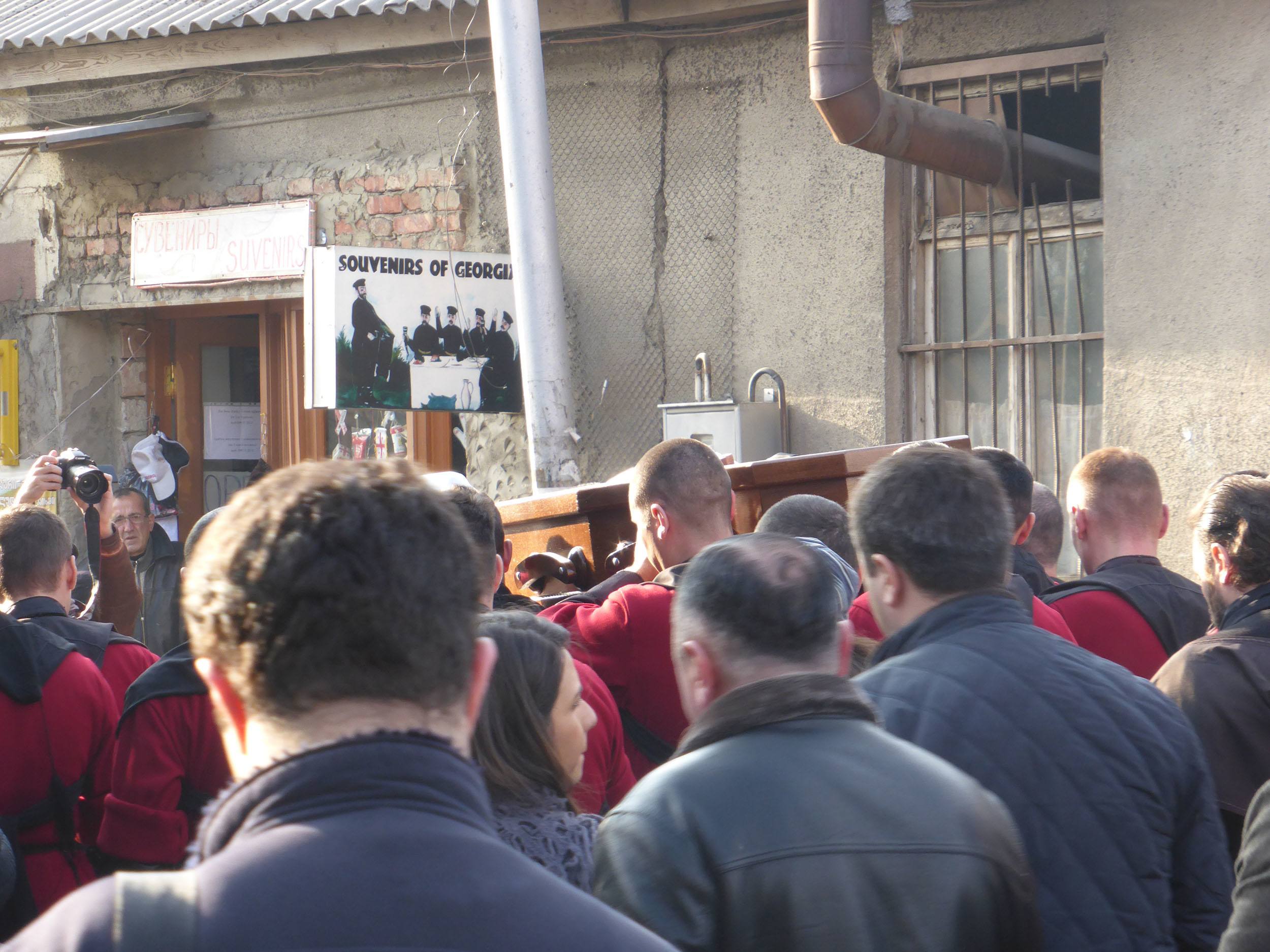 Georgians following a funeral procession with open coffin through the streets of Tbilisi Georgia