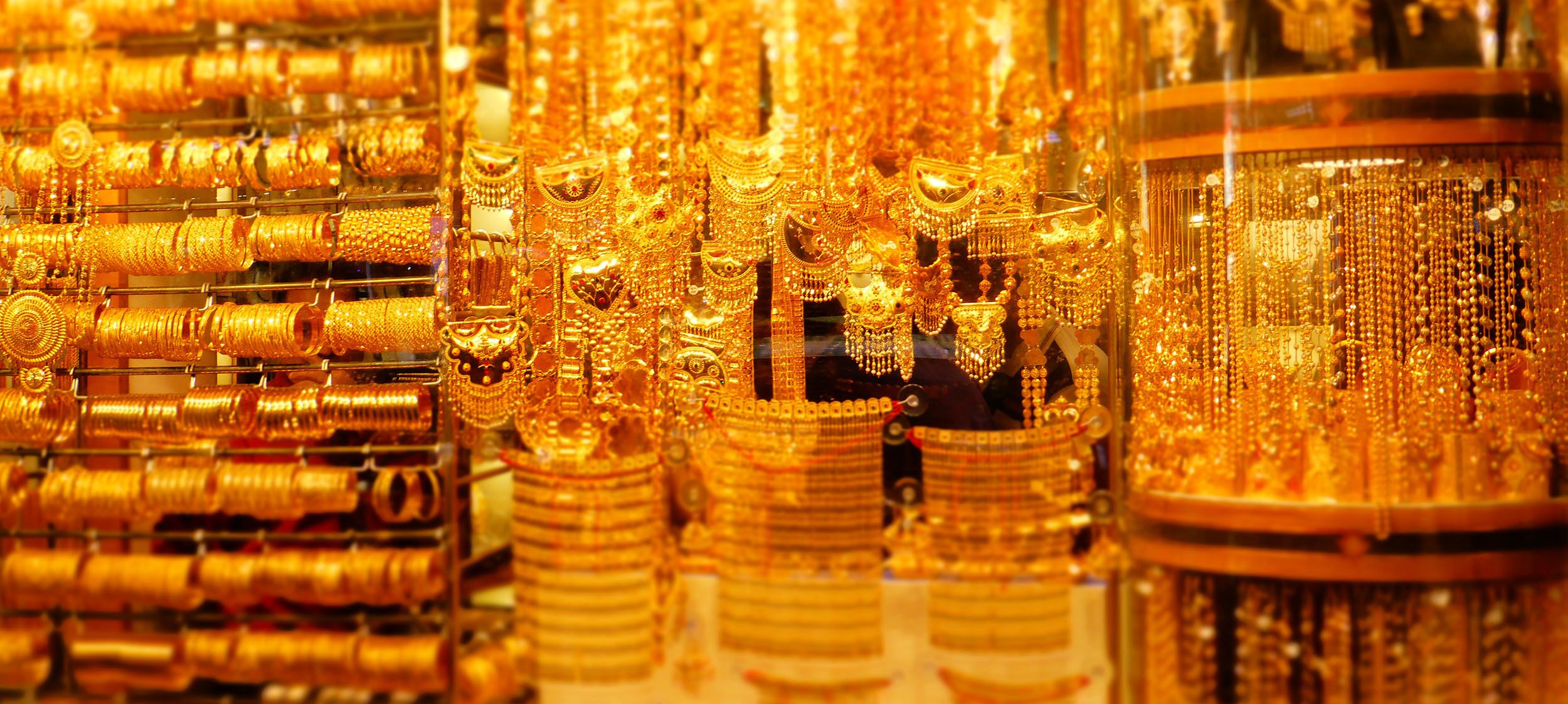 Gold jewellery inside shop window Dubai United Arab Emirates