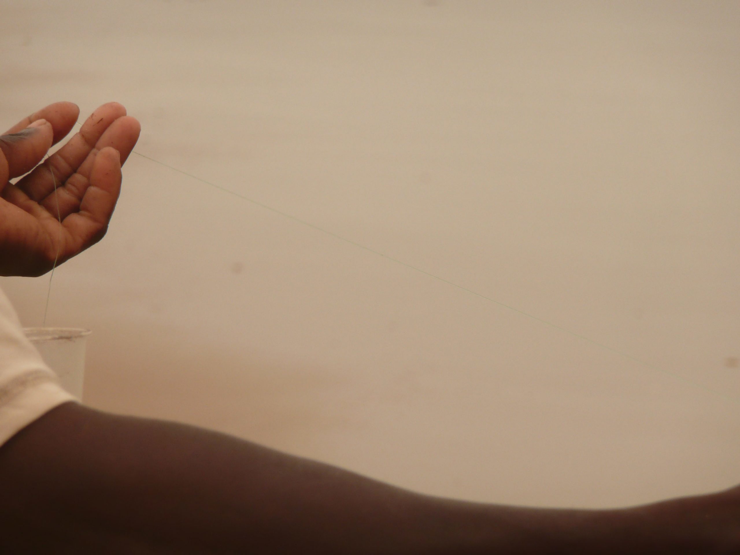 Hand of man fishing on Tofo Beach Mozambique