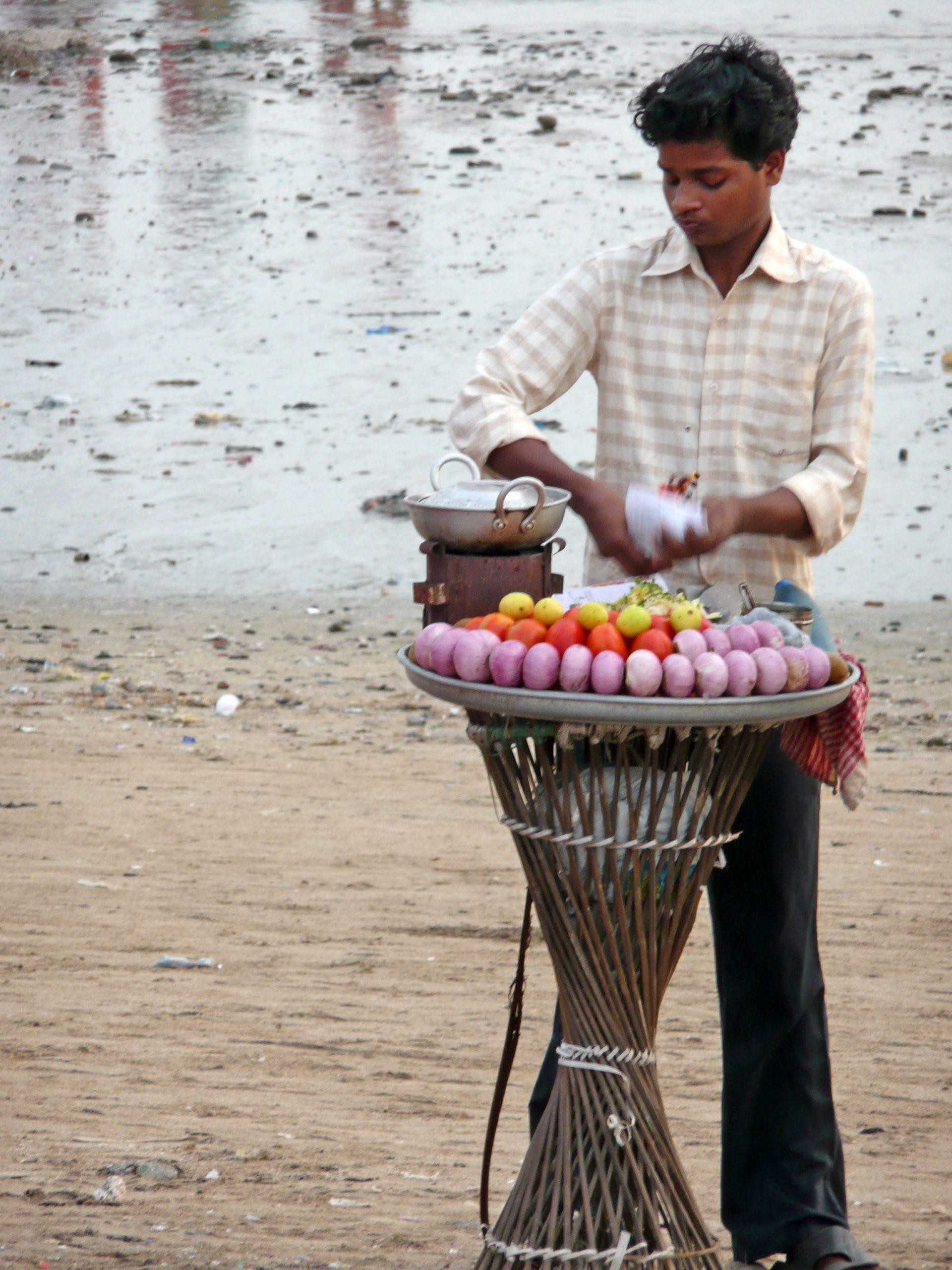 Indian boy working at stall on Chowpatty Beach Mumbai India