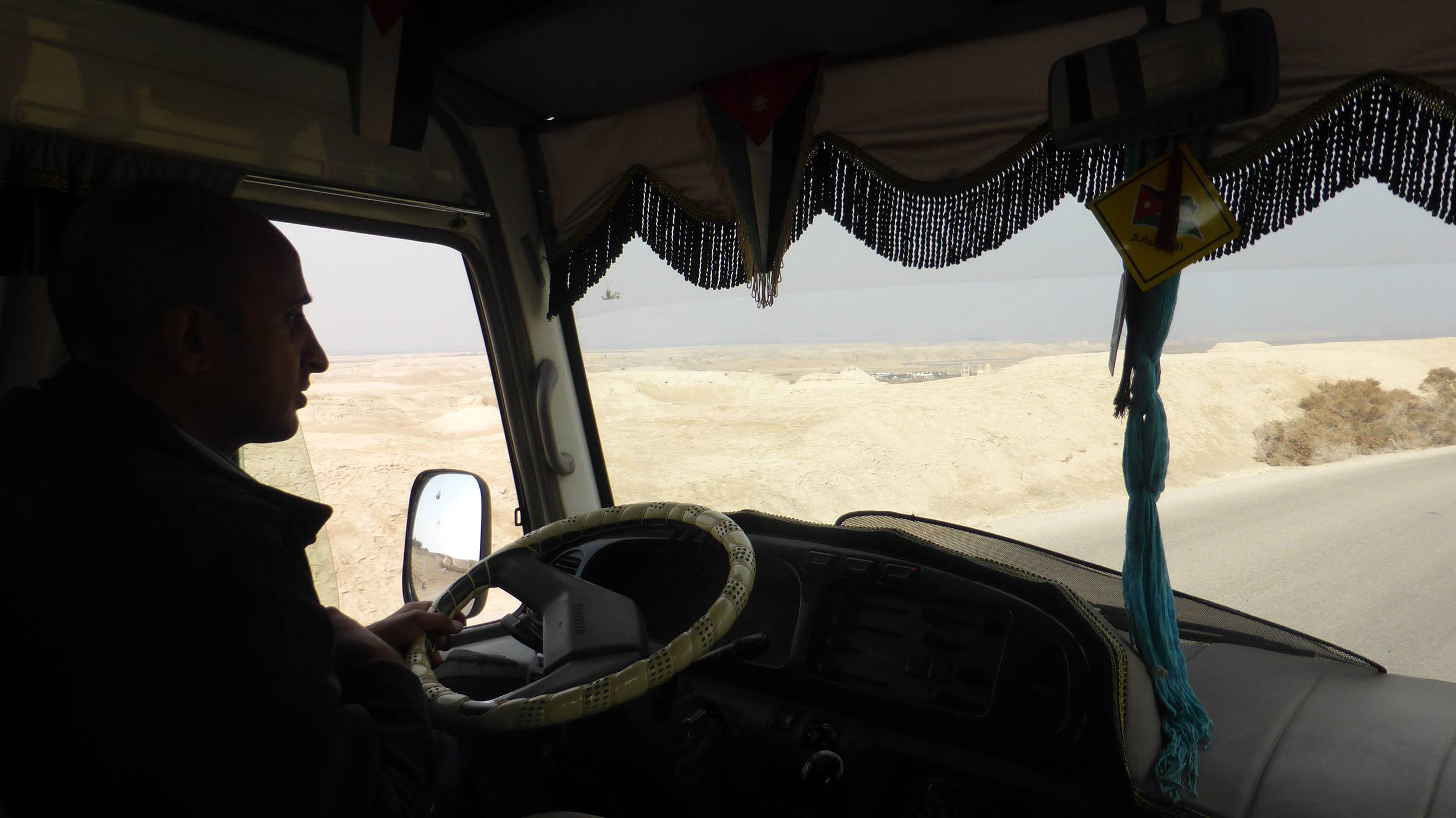 Jordanian man driving van towards Mt Nebo Jordan