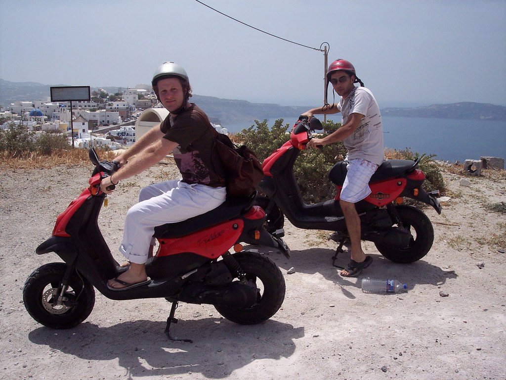 Jorge and Ben driving mopeds on Santorini in Greece