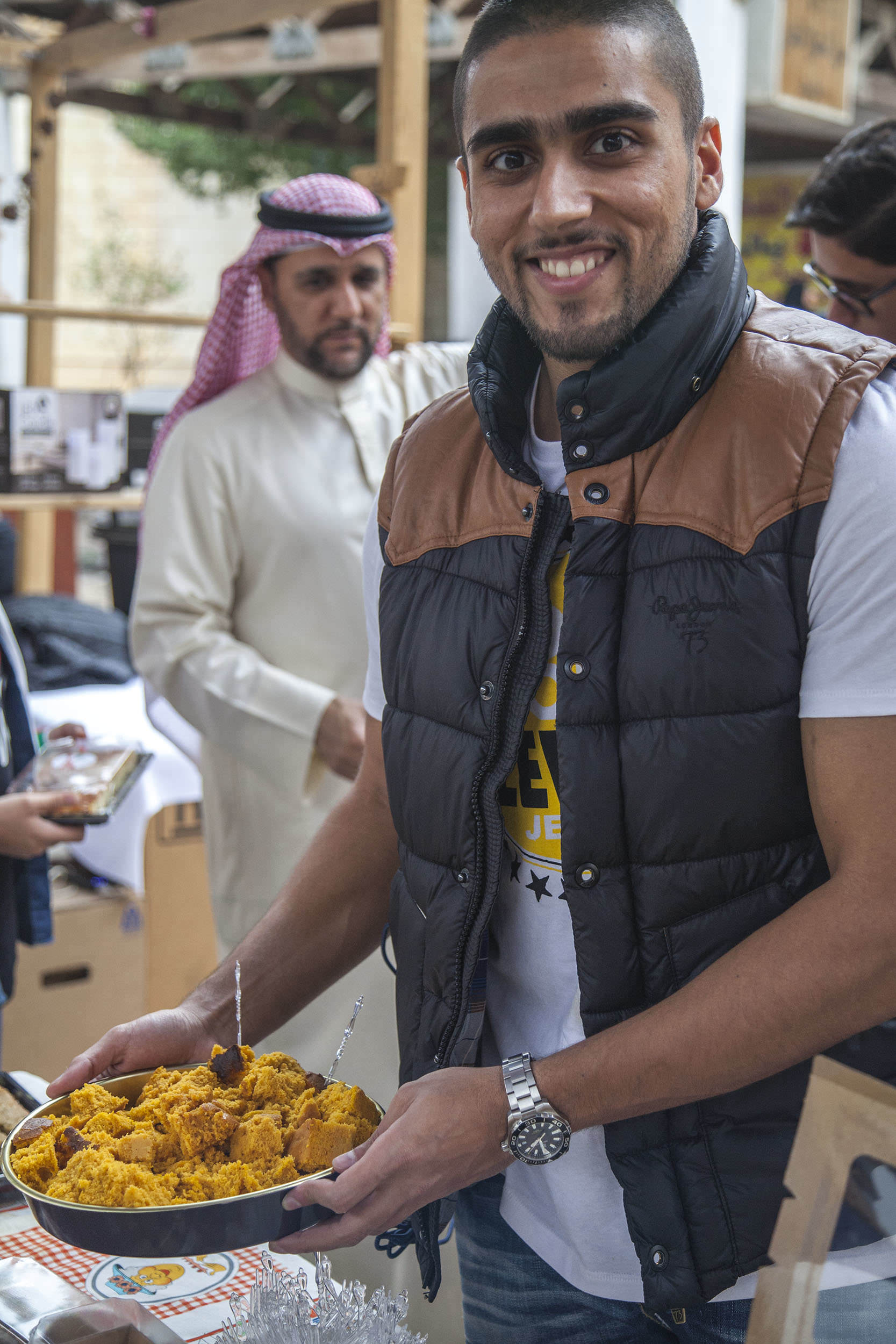 Kuwaiti man selling pumpkin cake at a stall in Souq Al-Mubarakiya Kuwait