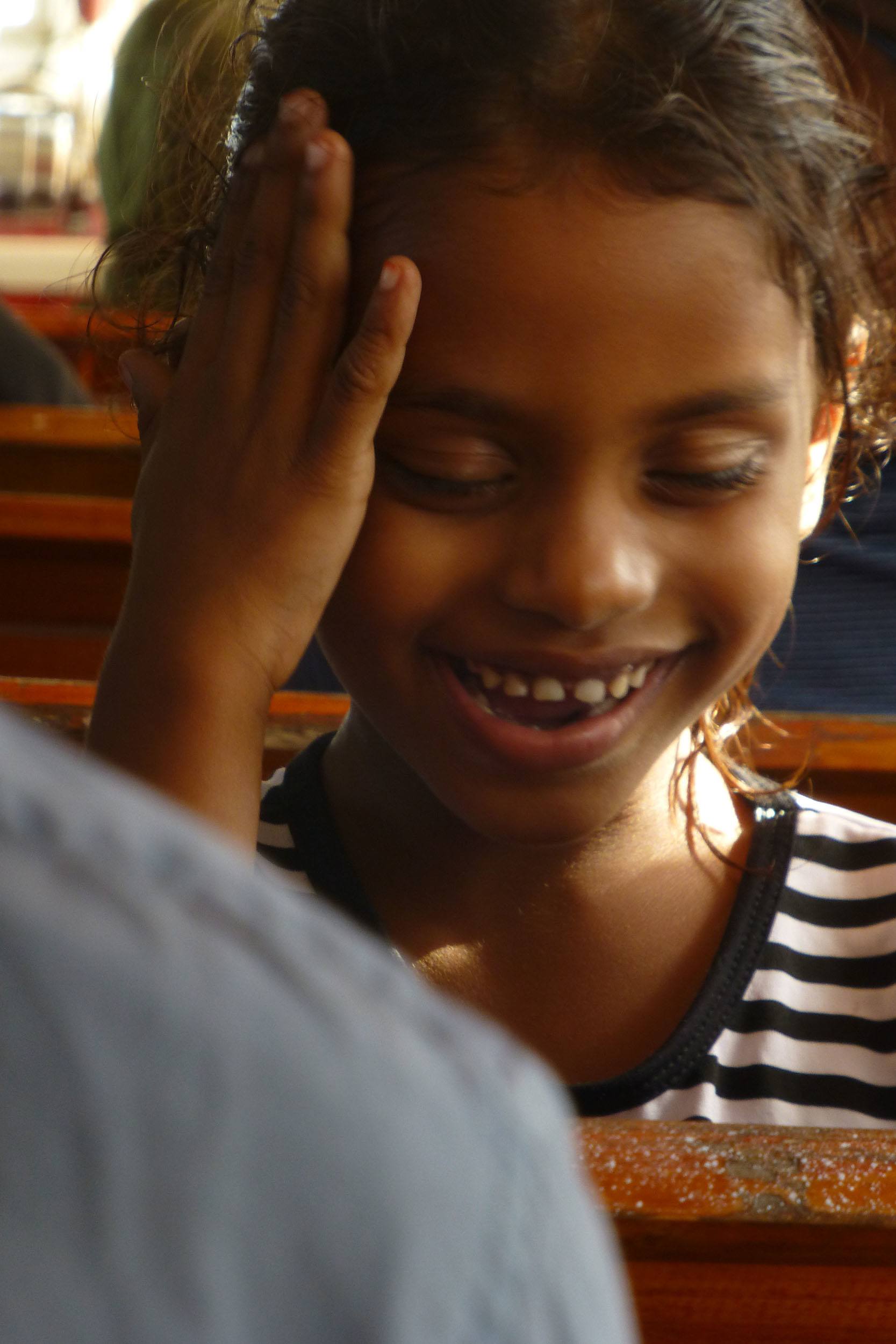 Maldivian girl smiling on ferry beween islands the Maldives