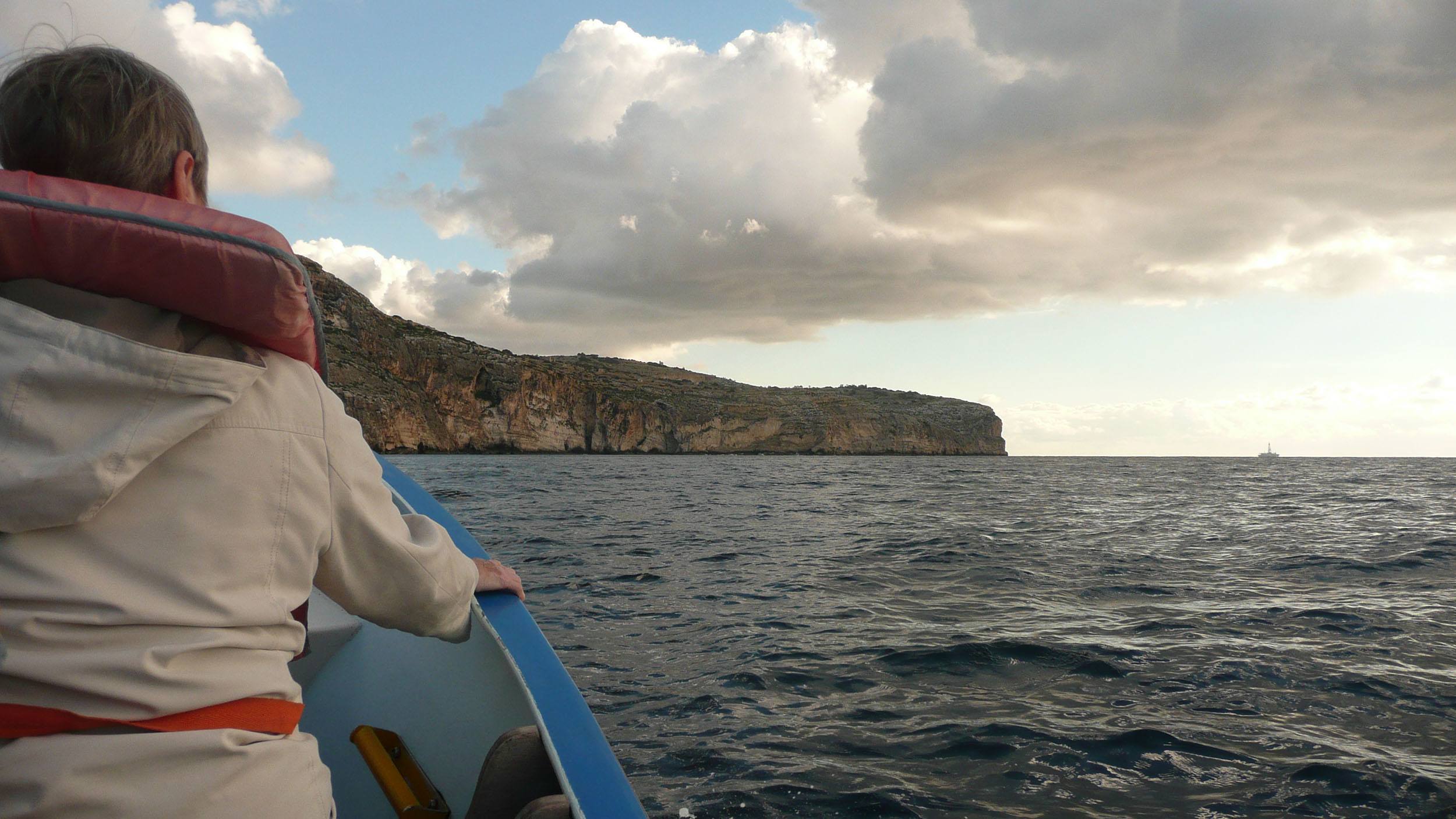 Man in boat en route to the Blue Grotto Malta