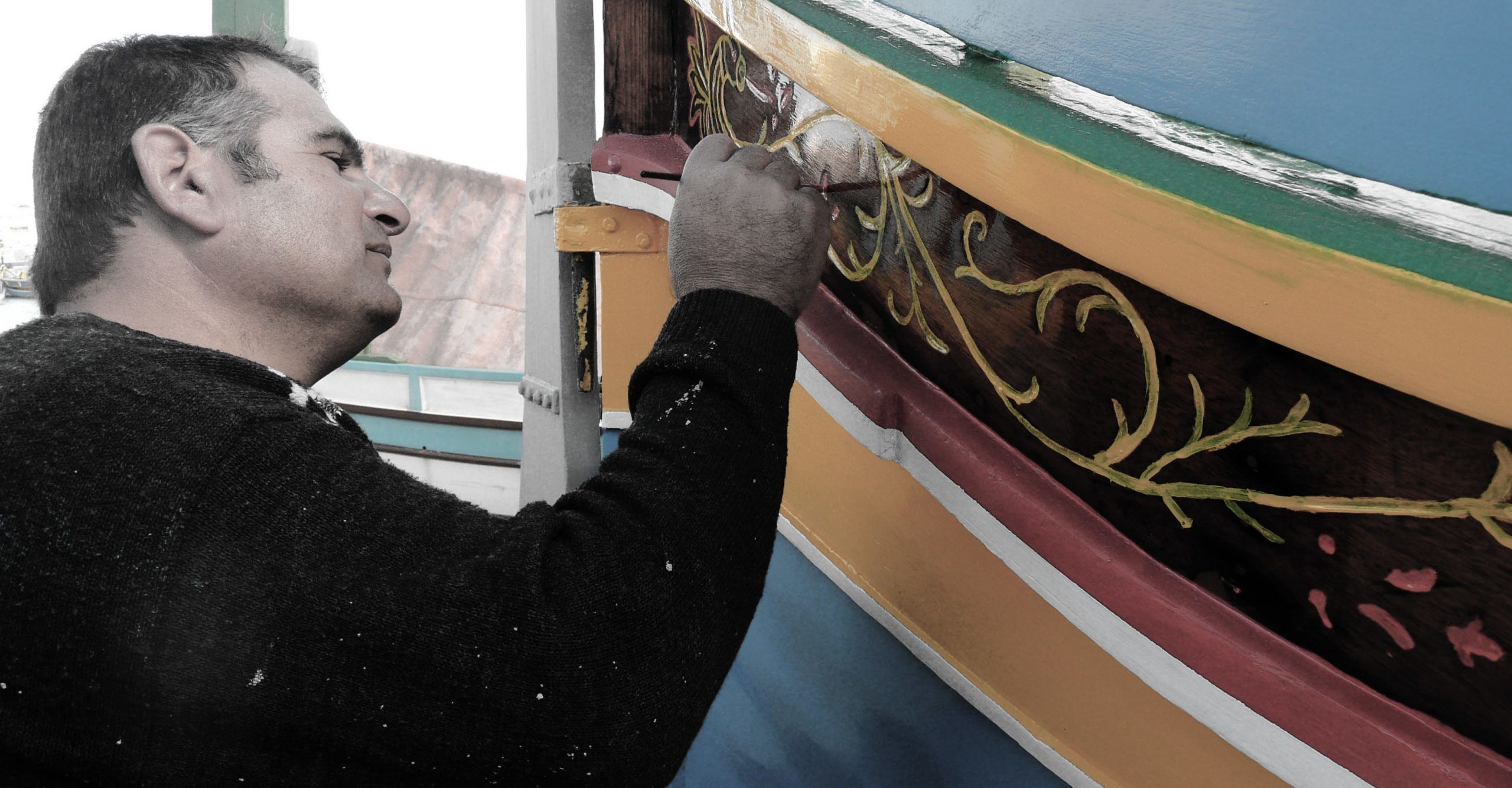 Man painting boat in Marsaxlokk Malta