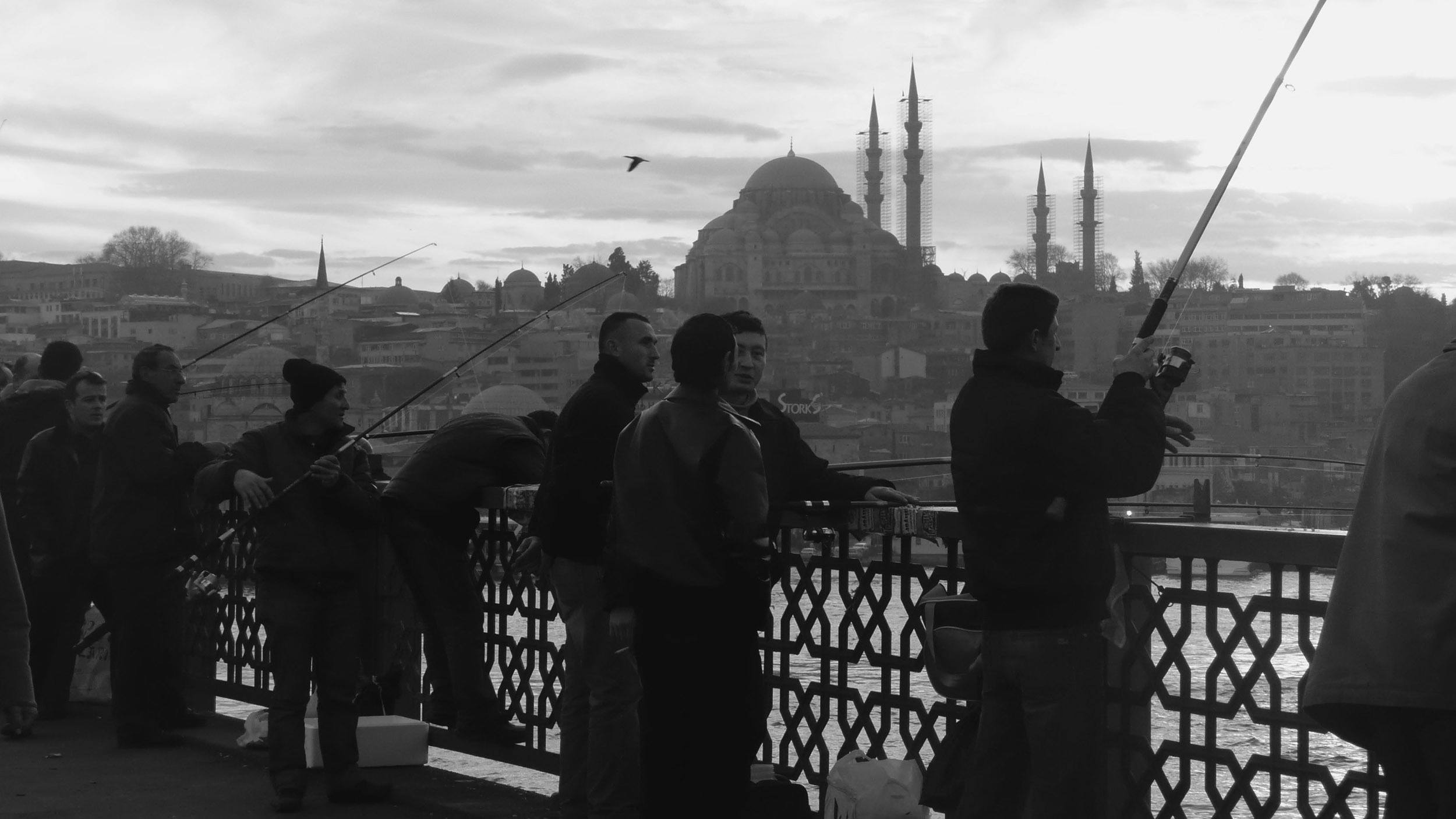 Men fishing off Galata Bridge in Istanbul Turkey