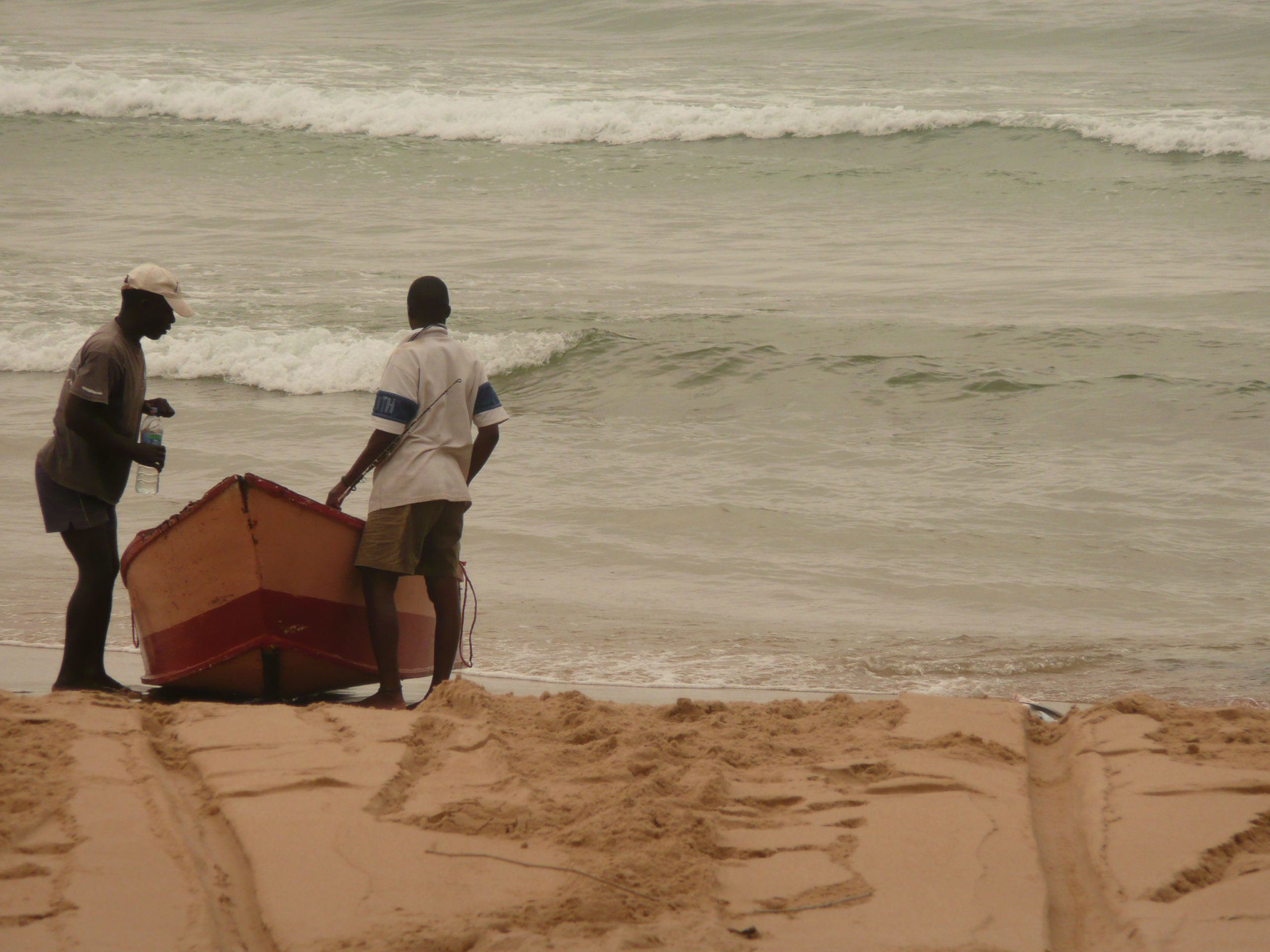 Men launching a boat on Tofo Beach Mozambique