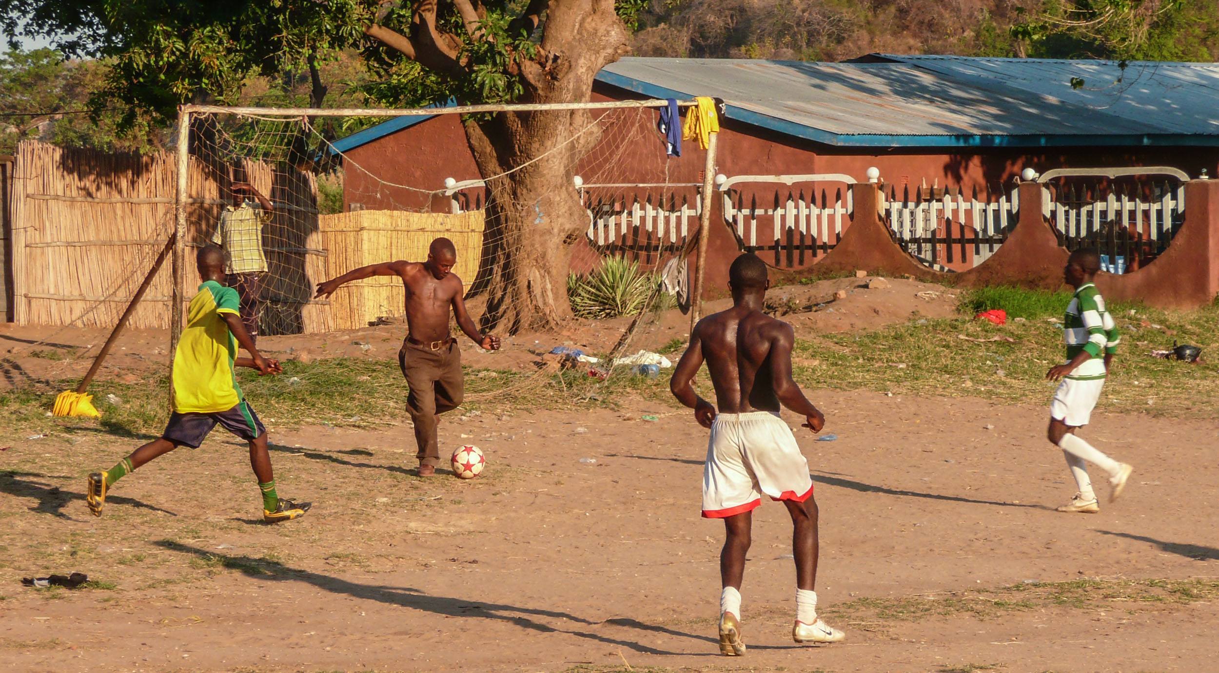 Men playing football in Nkhata Bay Malawi