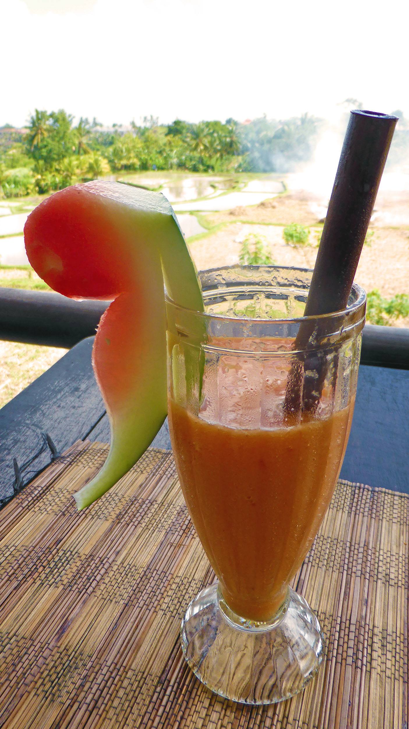 Papaya with tumeric juice at Cafe Pomegranate along Jalan Subak Sok Wayah in Ubud Bali Indonesia