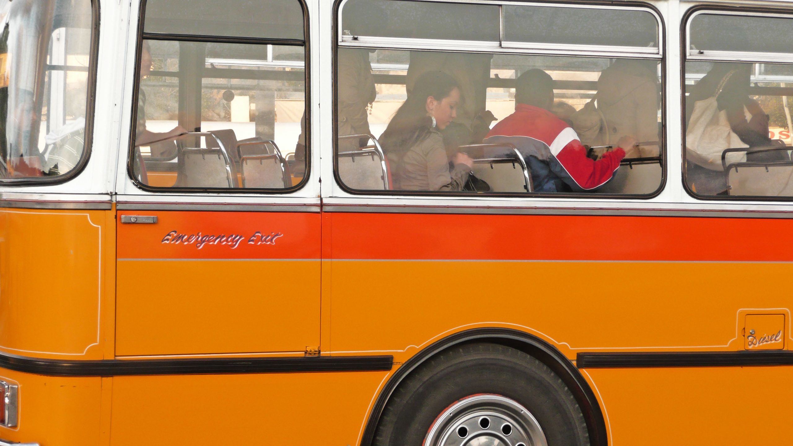 People on board orange public bus in Valletta Malta