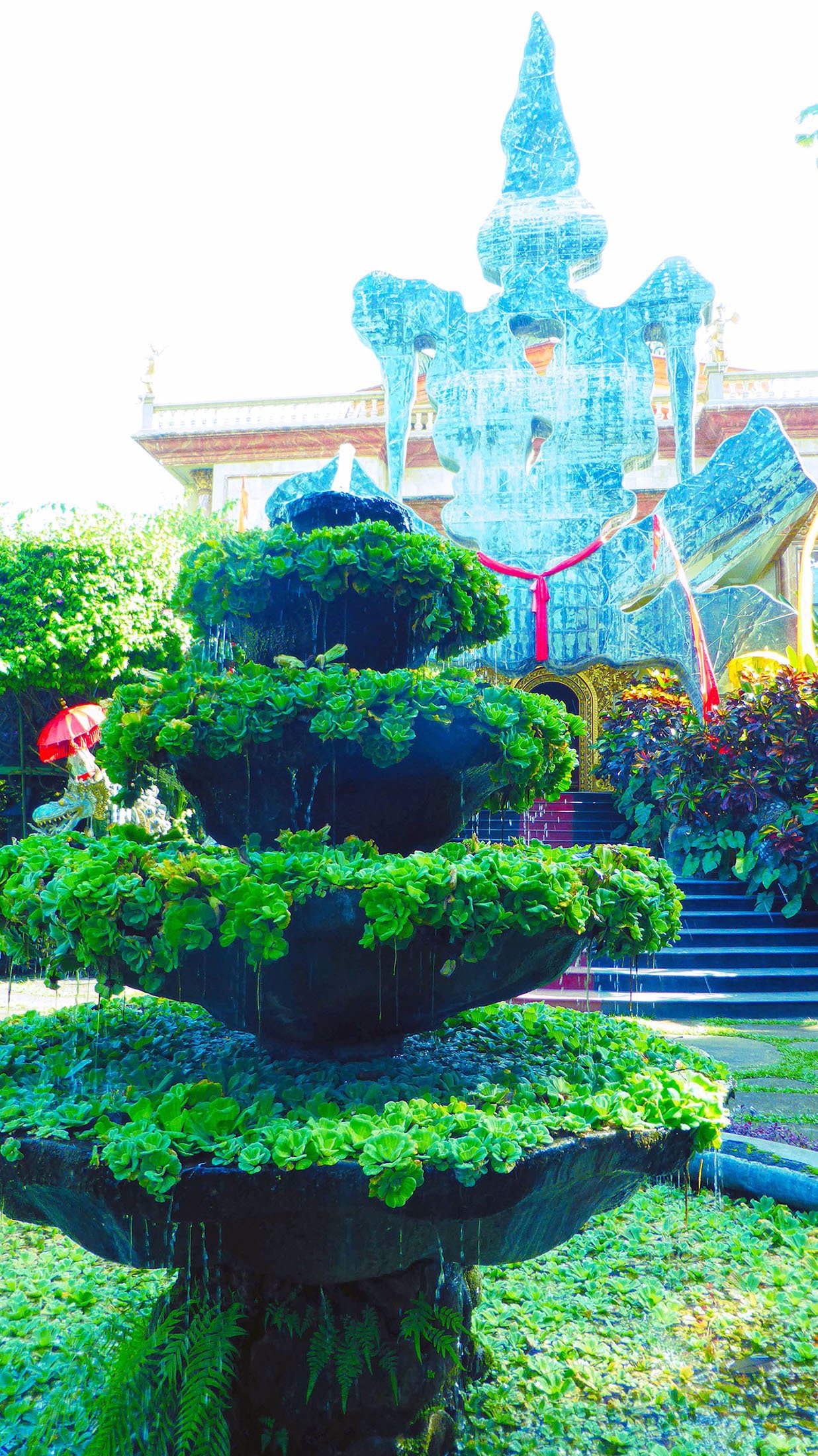 Plant filled fountain in gardens of Don Blanco Museum Ubud Bali Indonesia