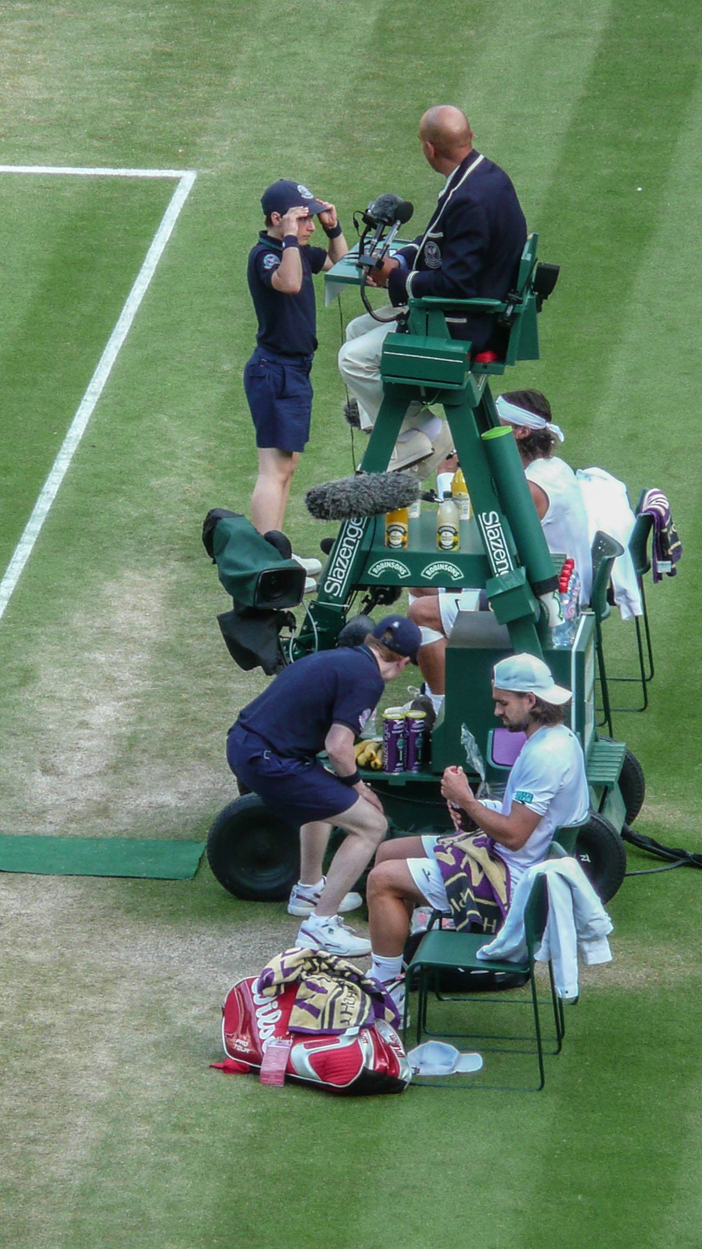 Professional players with referee and ball boys and girls at Wimbledon London England United Kingdom