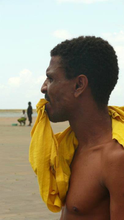 Shirtless Kenyan man on a beach near Mombasa Kenya