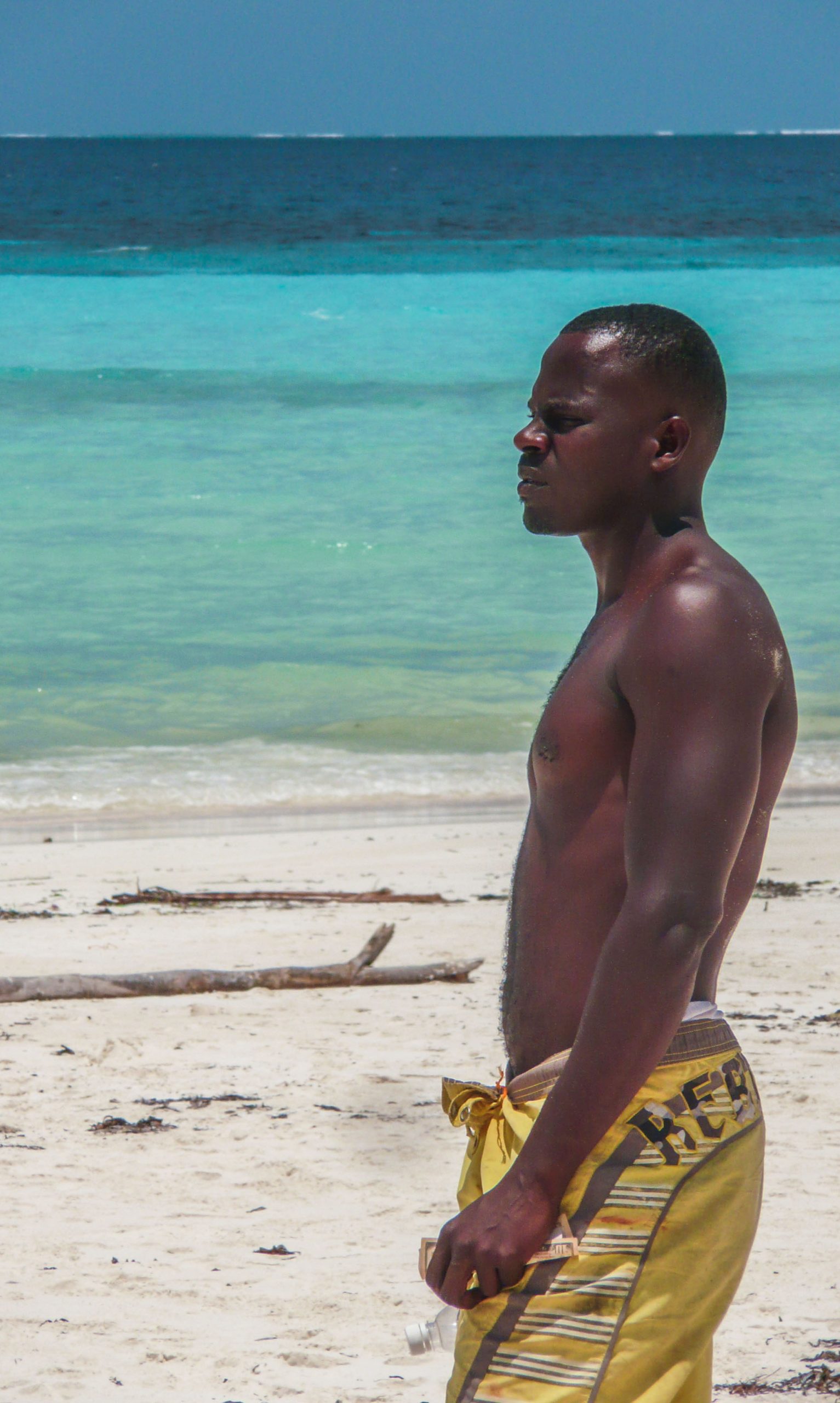 Shirtless Tanzanian man on beach of Zanzibar Tanzania