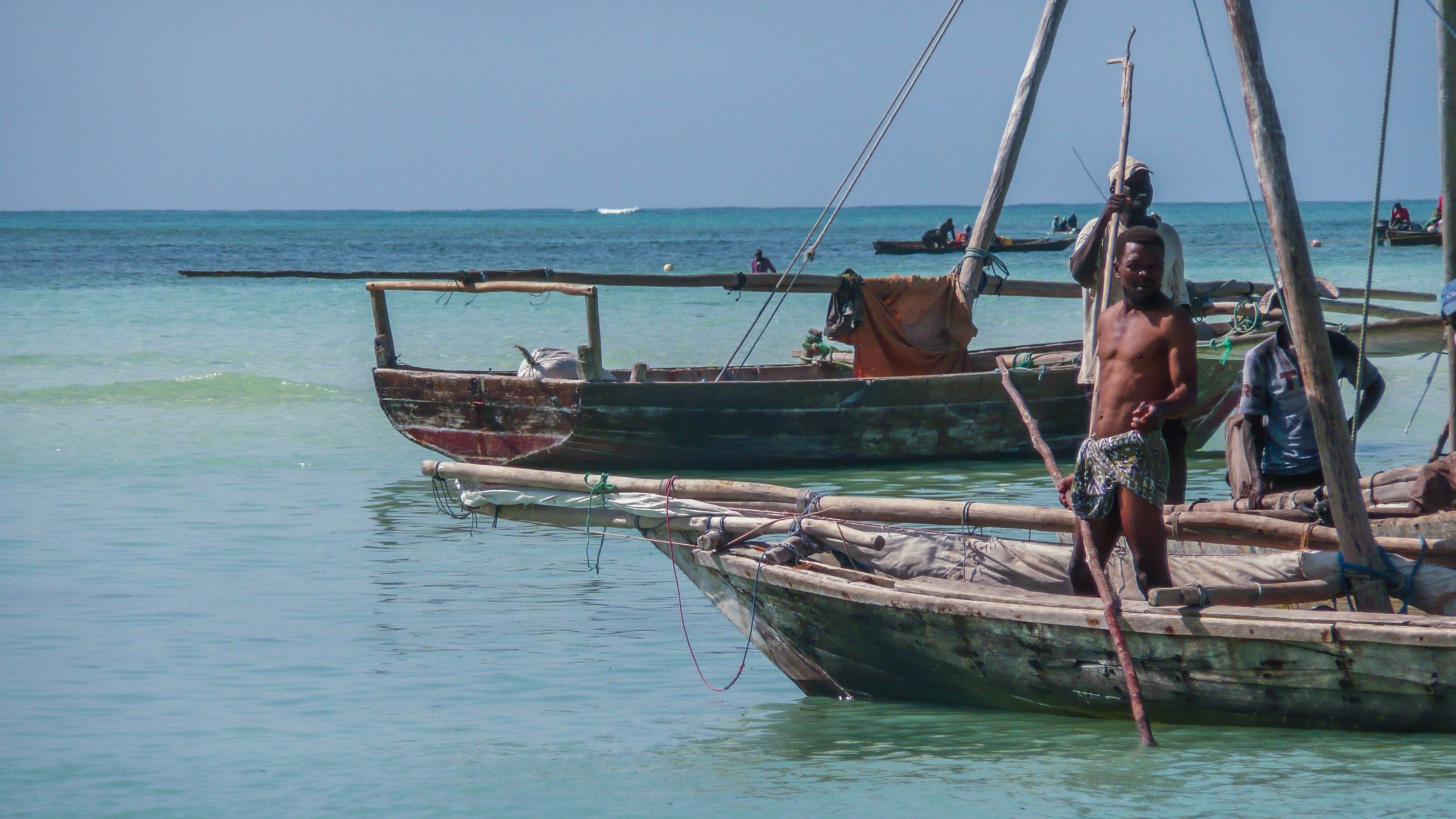 Shirtless Tanzanian man on dhow near Nungwi Beach Zanzibar Tanzania