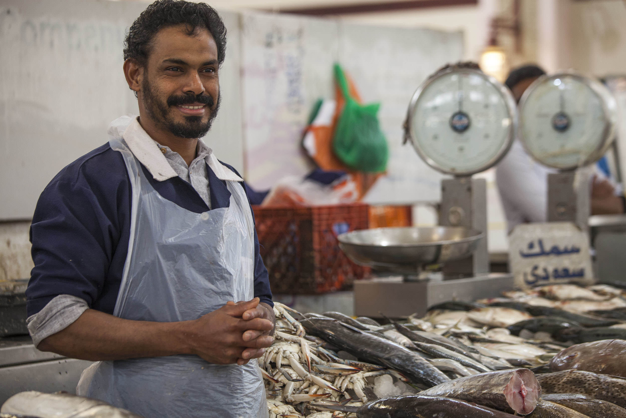 Smiling man at a stall in the Central Fish Market Kuwait