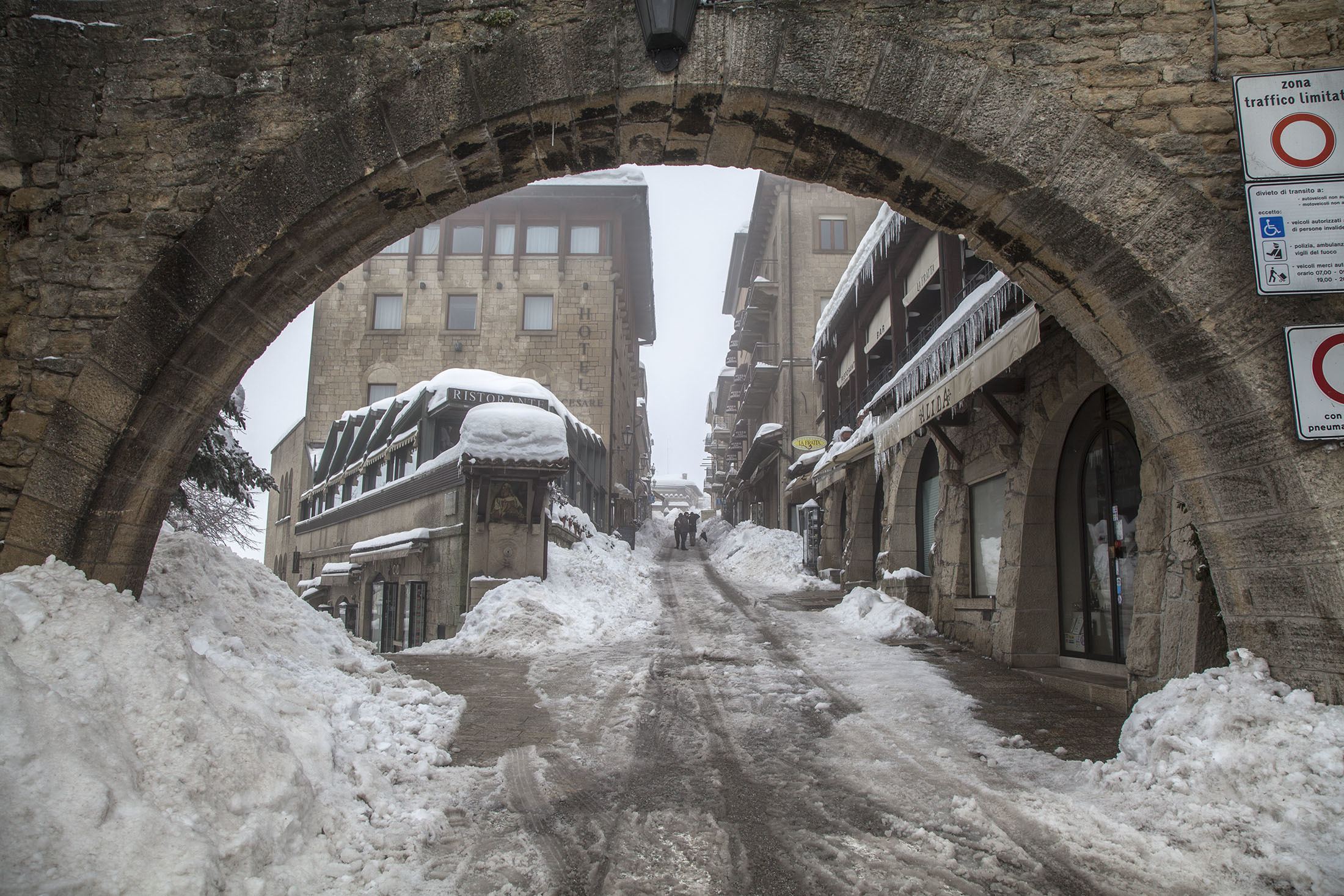 Stone arch at entry to City of San Marino in winter