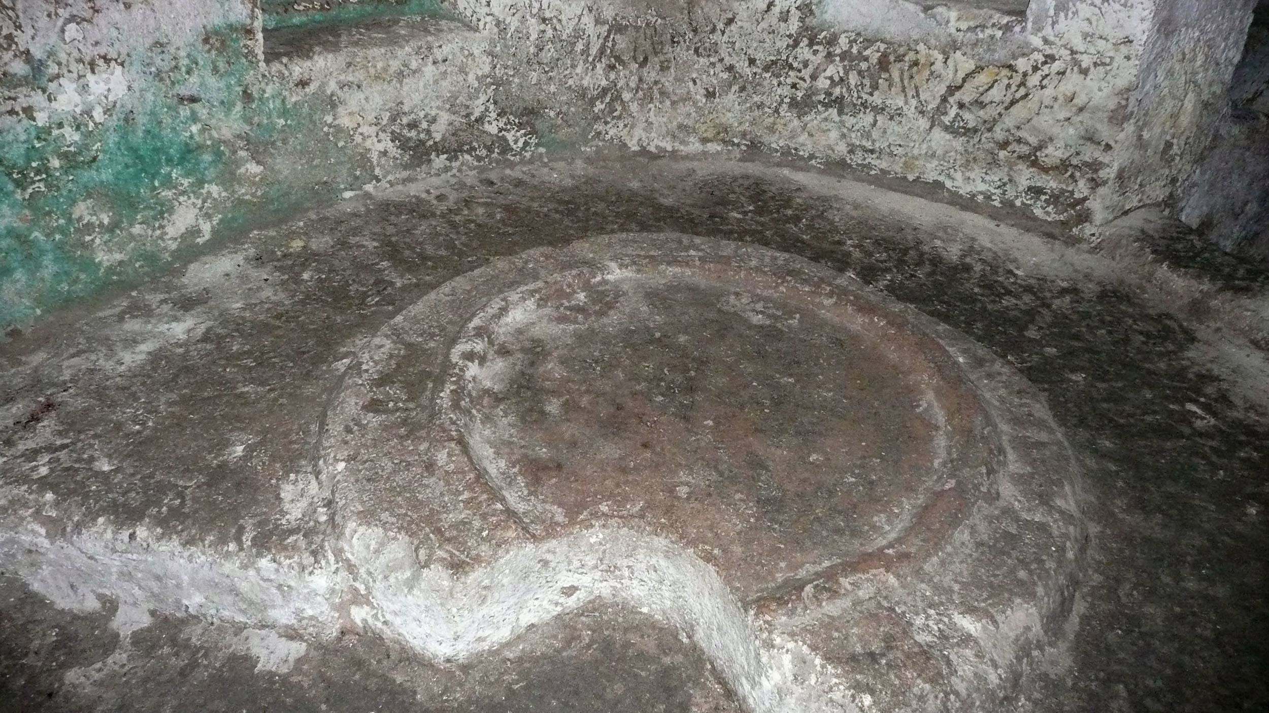 Stone floor with circular element inside St Paul's Catacombs Malta