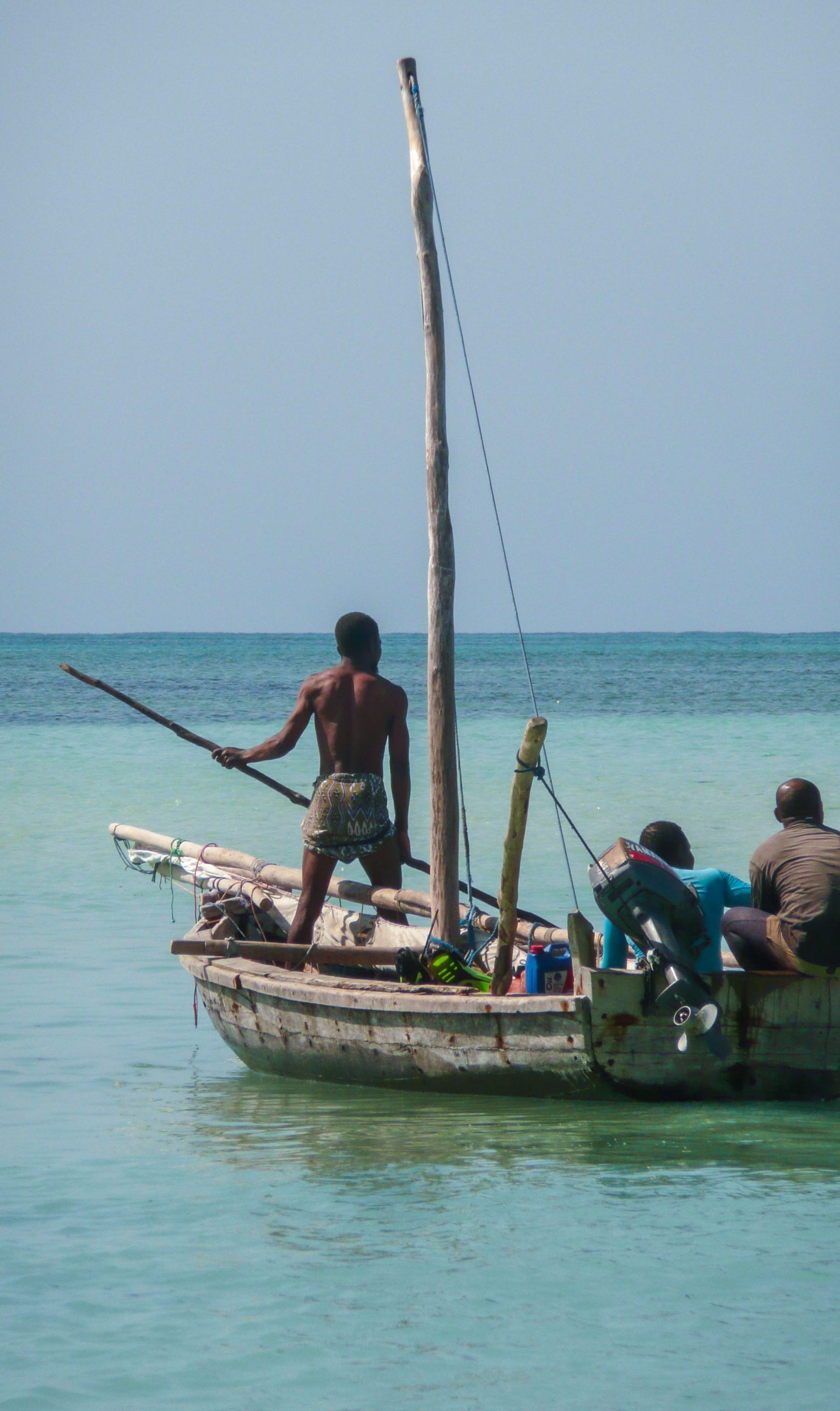 Tanzanian men manning a dhow near Nungwi Beach Zanzibar Tanzania
