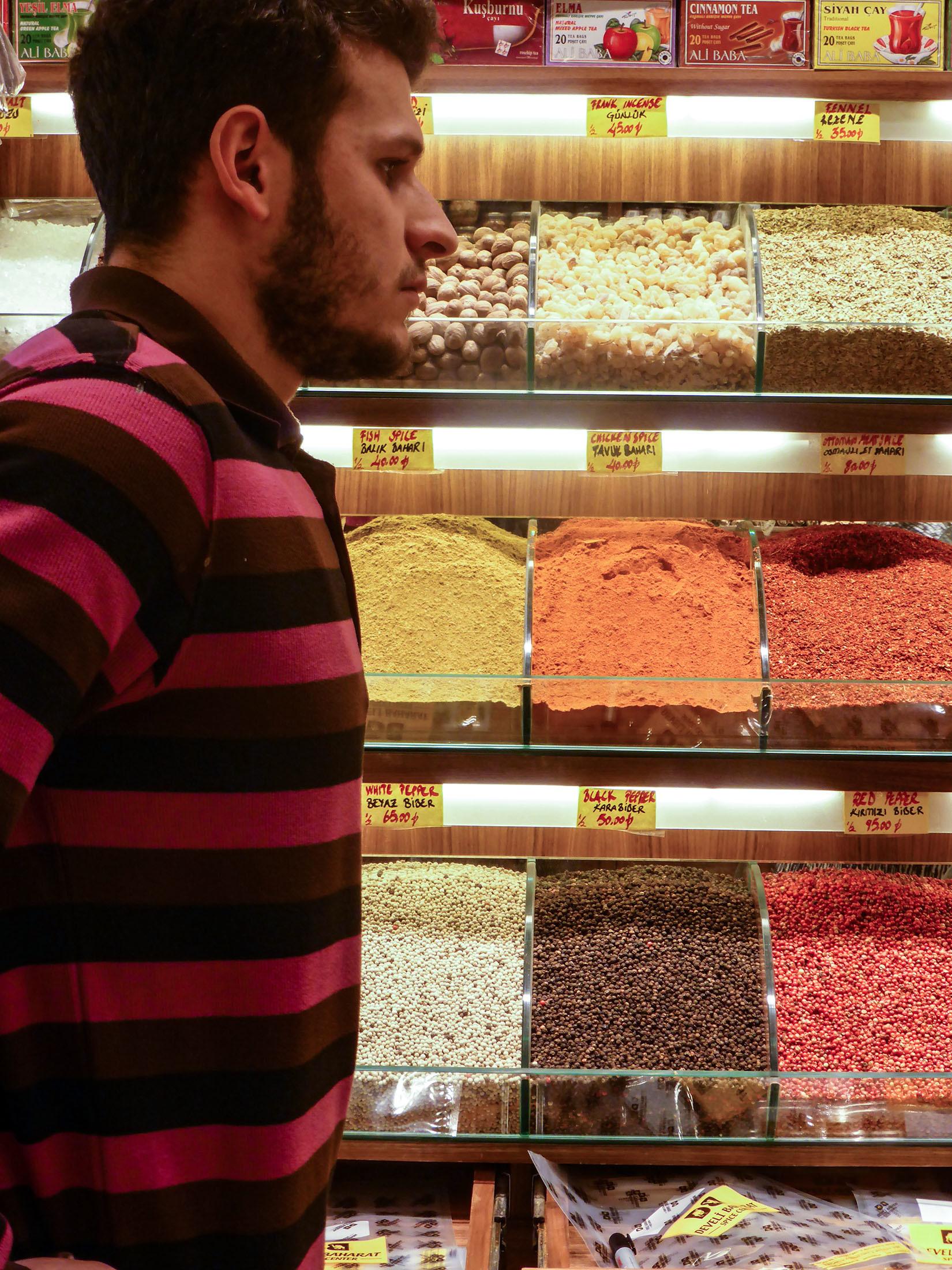 Turkish man working in a Grand Bazaar spice and sweet store Istanbul Turkey