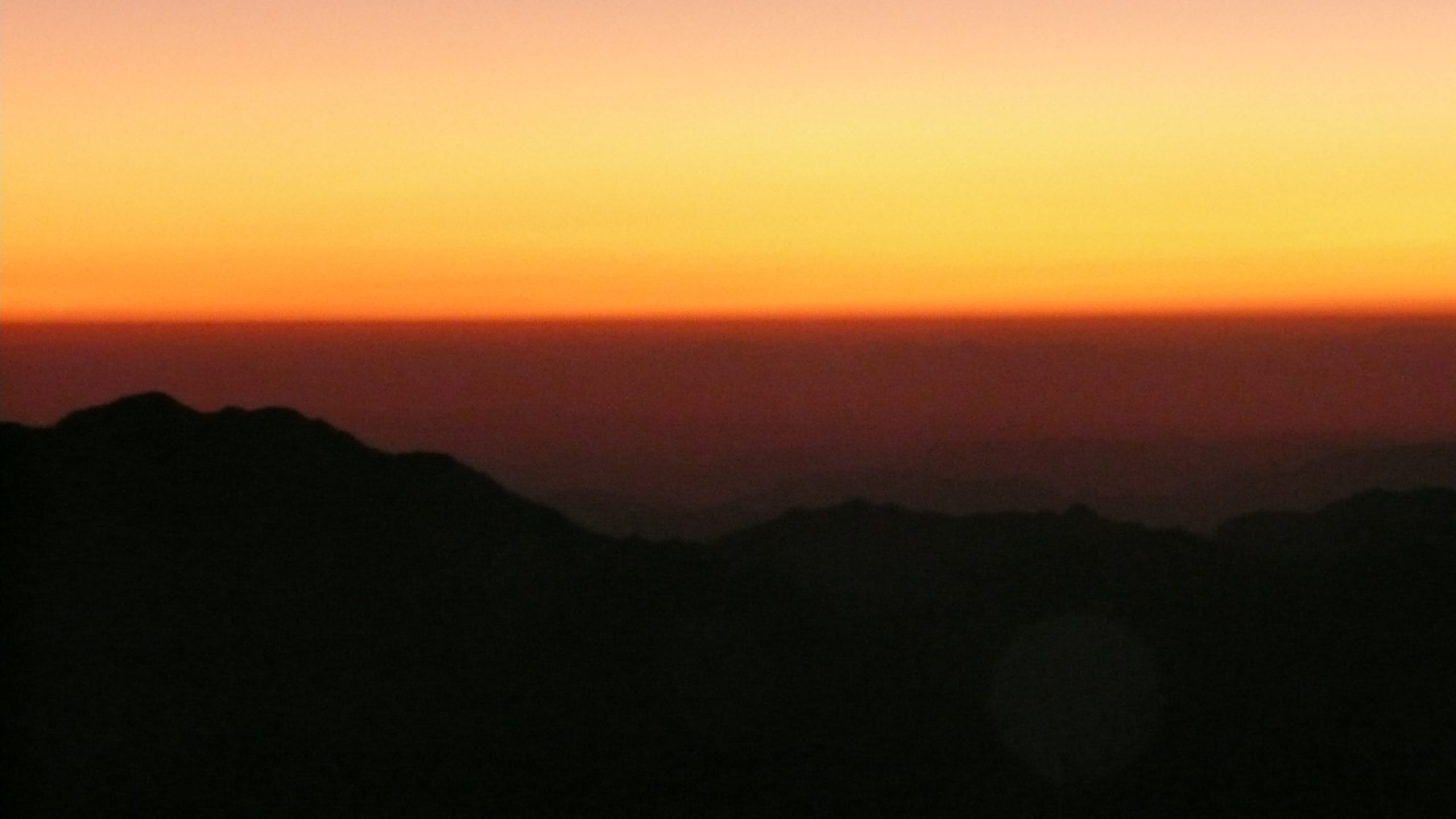 Yellow to orange and red sky at sunrise from Mt Sinai Egypt