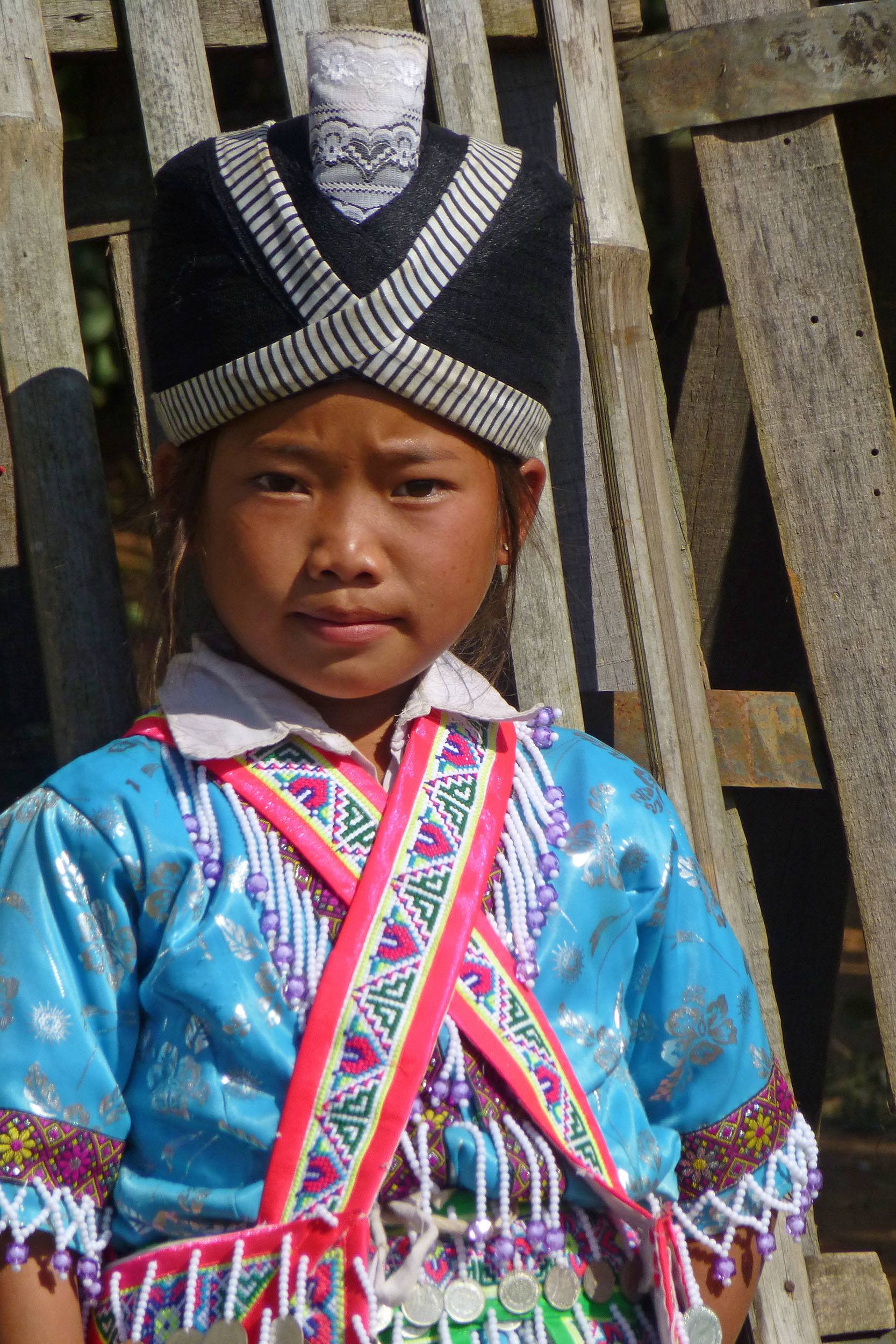 Young Akha girl dressed in New Years celebratory attire in Laos