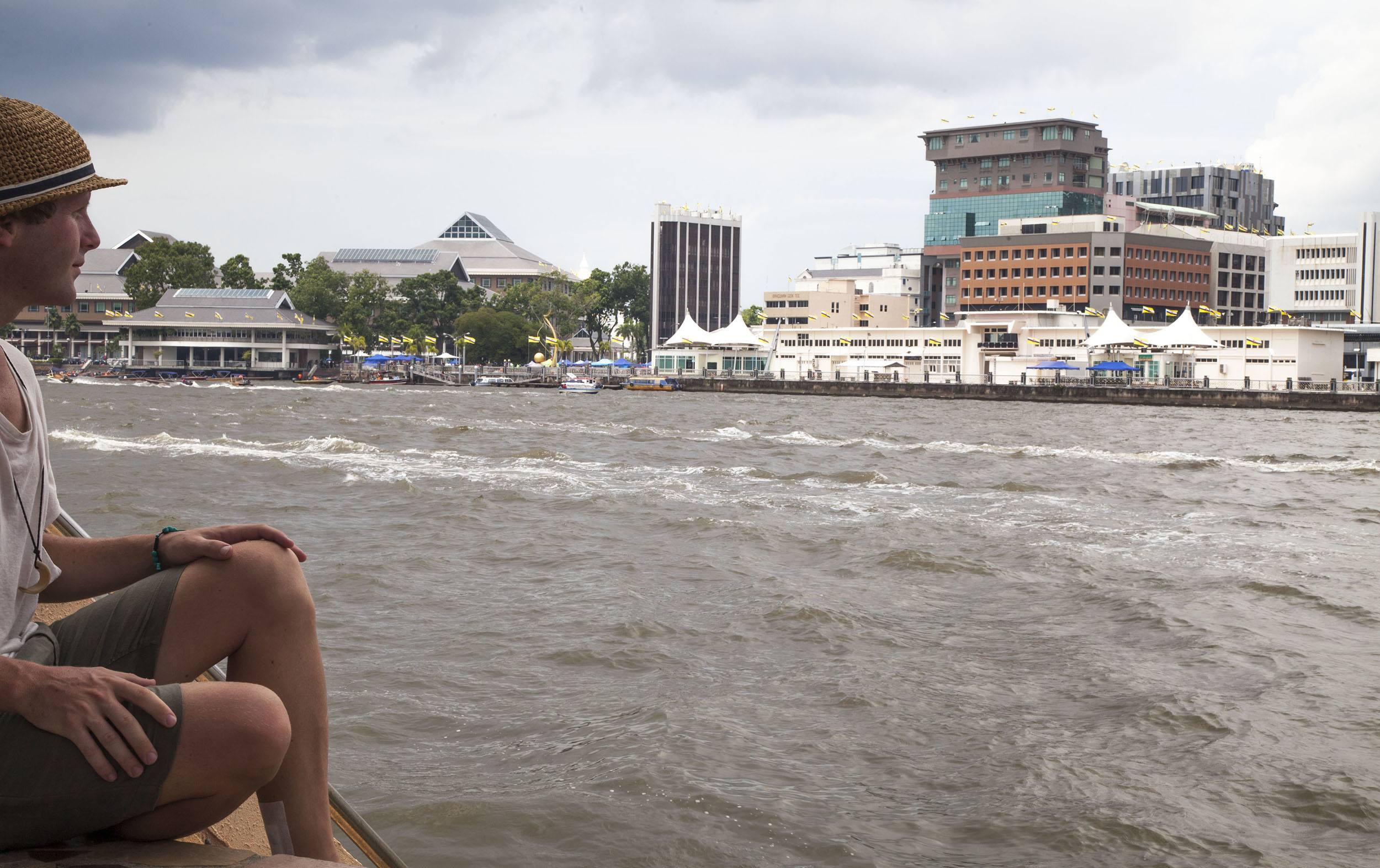 Ben sitting by the river in Kampung Ayer Bandar Seri Begawan Brunei