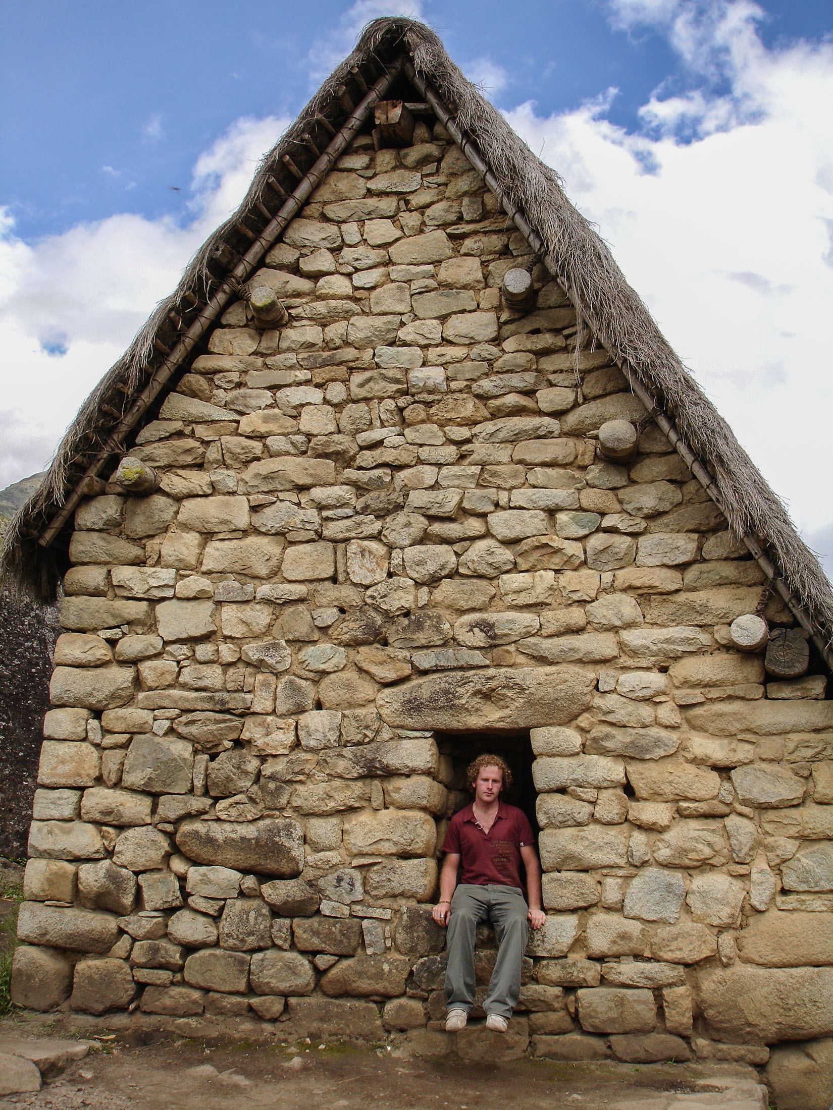 Ben sitting in window of stone house in Machu Picchu Peru