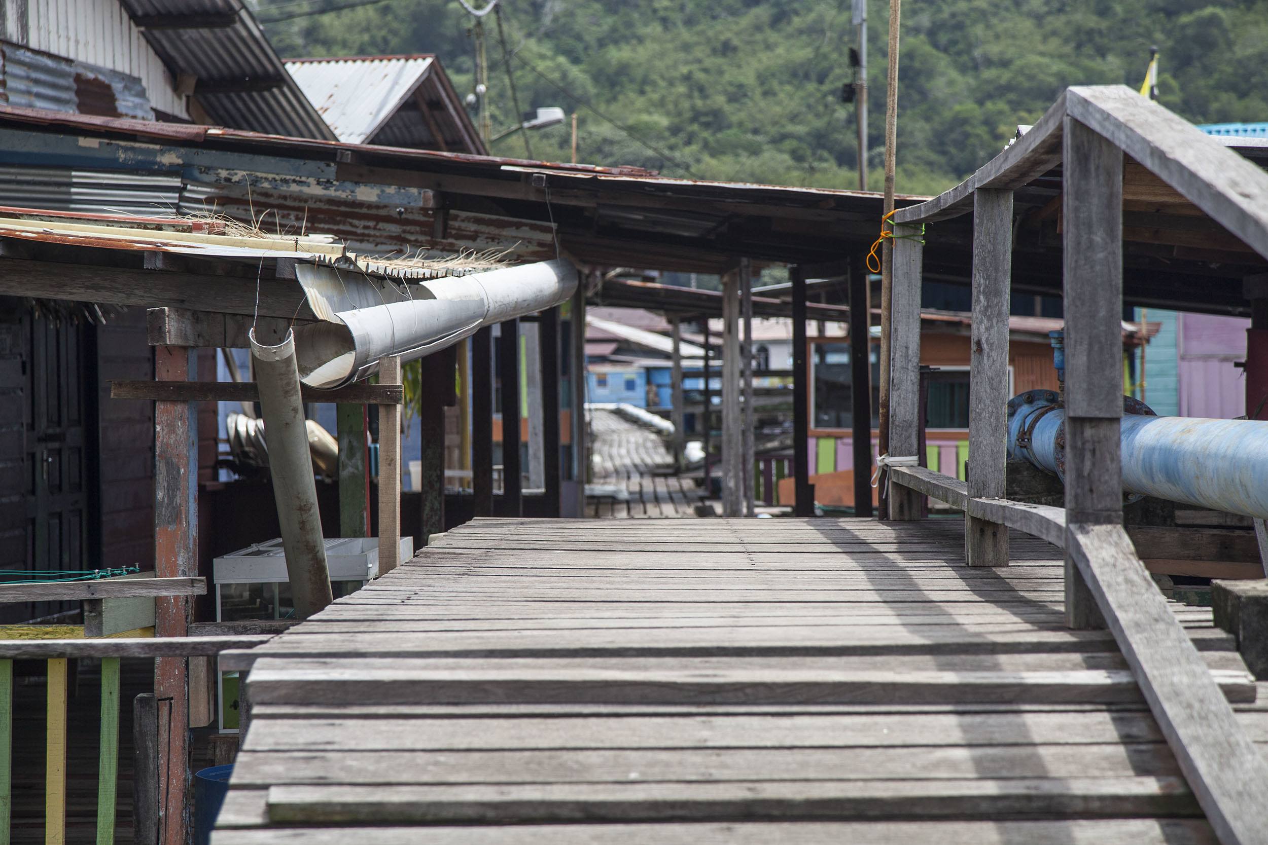 Bridge in boardwalk between homes in Kampung Ayer Bandar Seri Begawan Brunei