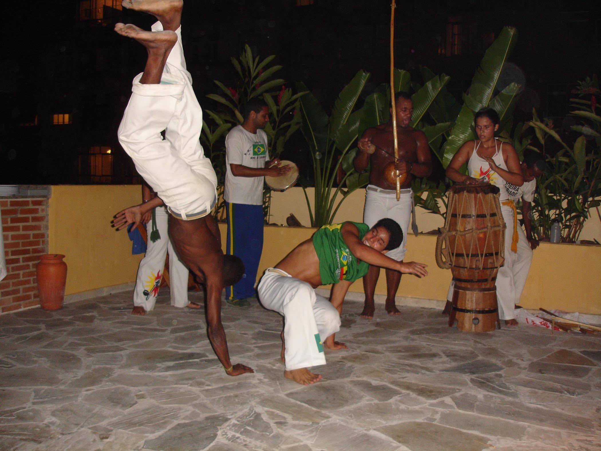 Capoeira performers performing on the roof terrace of Stone of a Beach Hostel in Rio de Janeiro Brazil