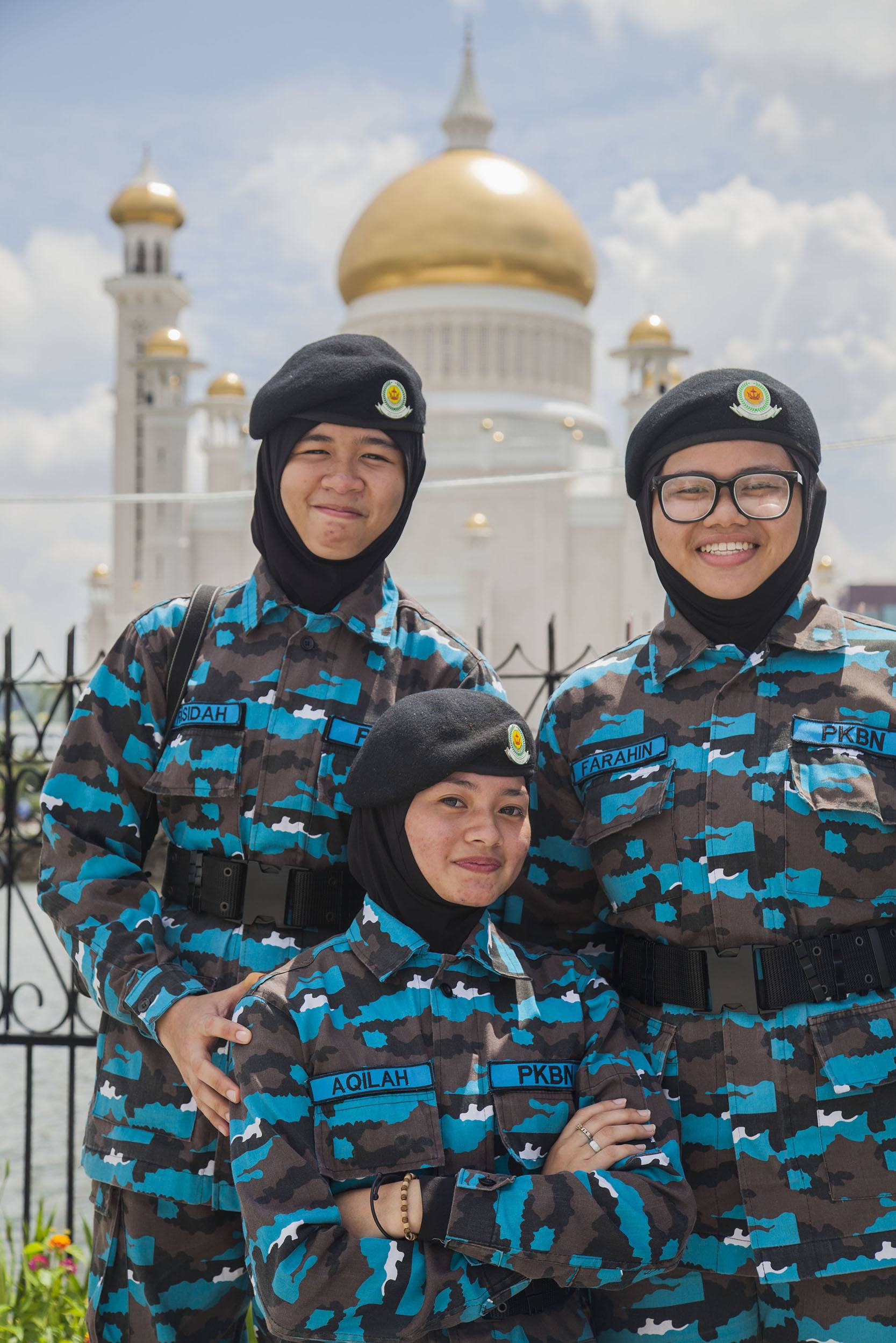 Female soldiers standing in front of Masjid Omar Ali Saifuddien in Bandar Seri Begawan Brunei