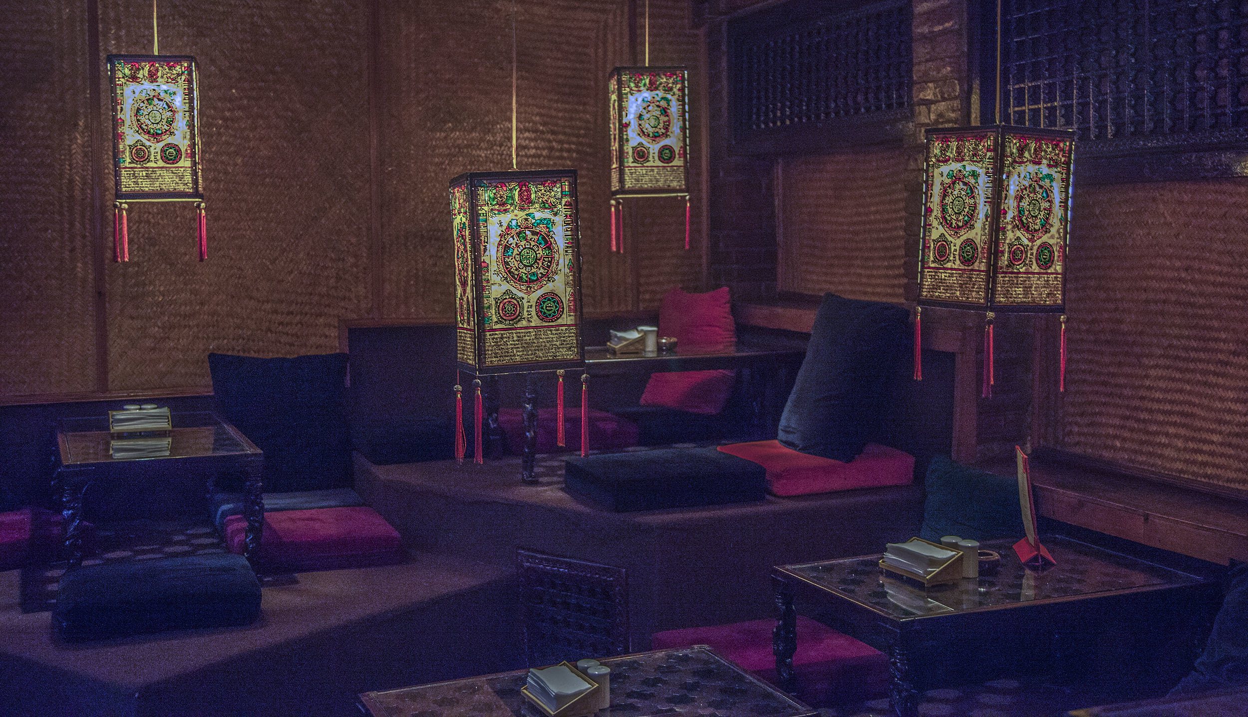 Lanterns hanging above cushions and low tables in Third Eye restaurant Kathmandu Nepal