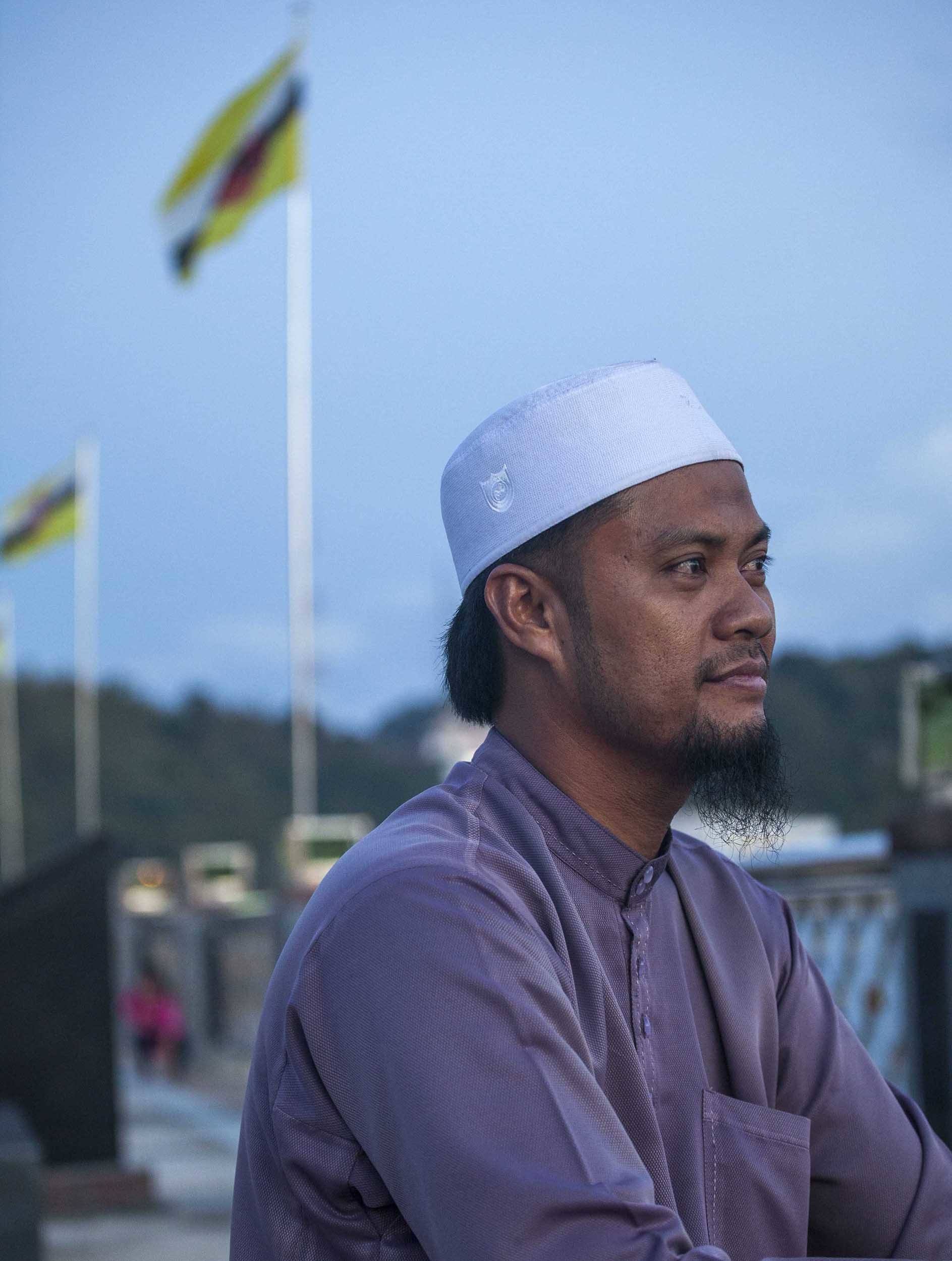 Man standing on the waterfront Promenade in Bandar Seri Begawan Brunei