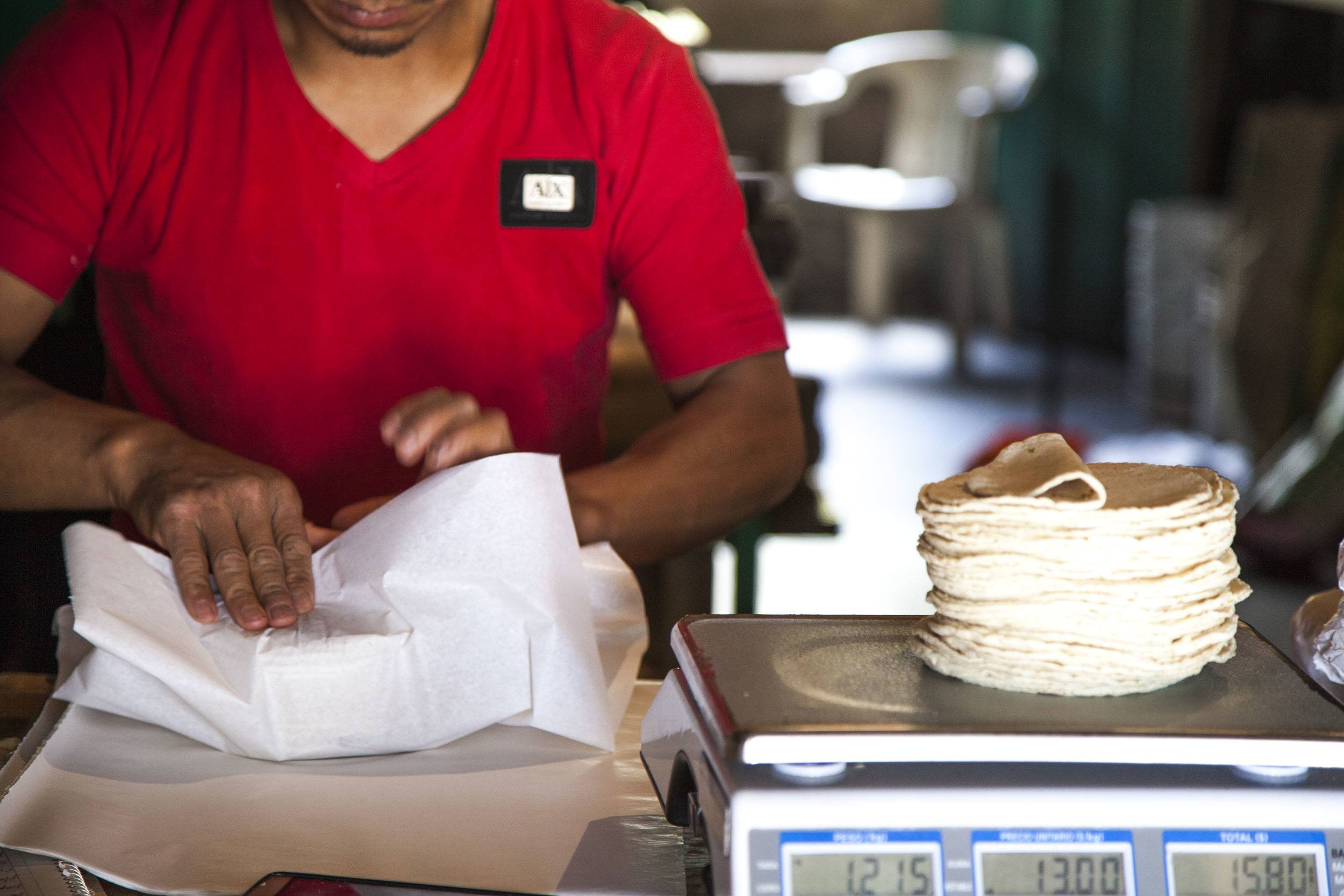 Man wrapping tortillas in San Juan Chamula Mexico