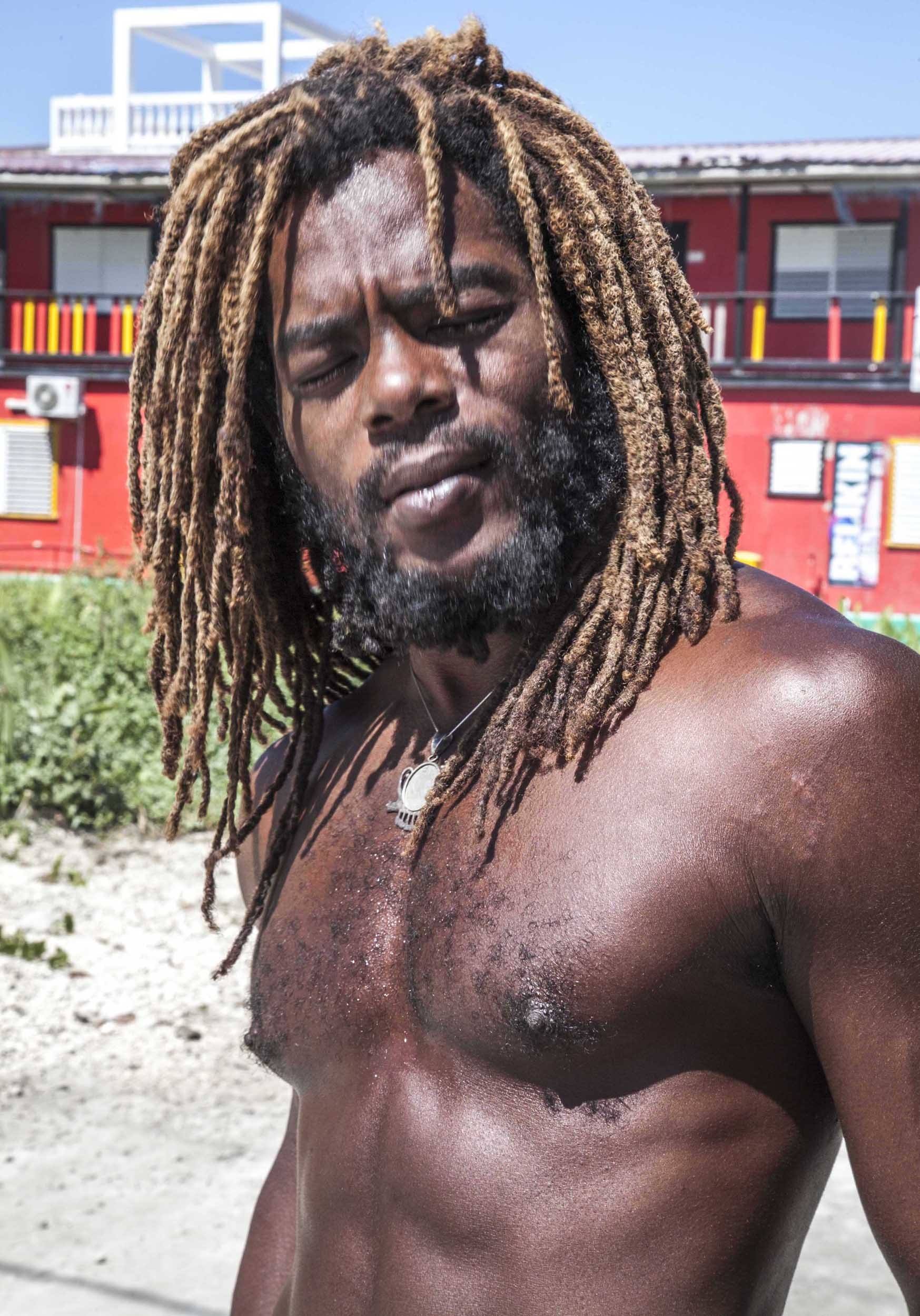 Shirtless man with dreadlocks on Caye Caulker Belize