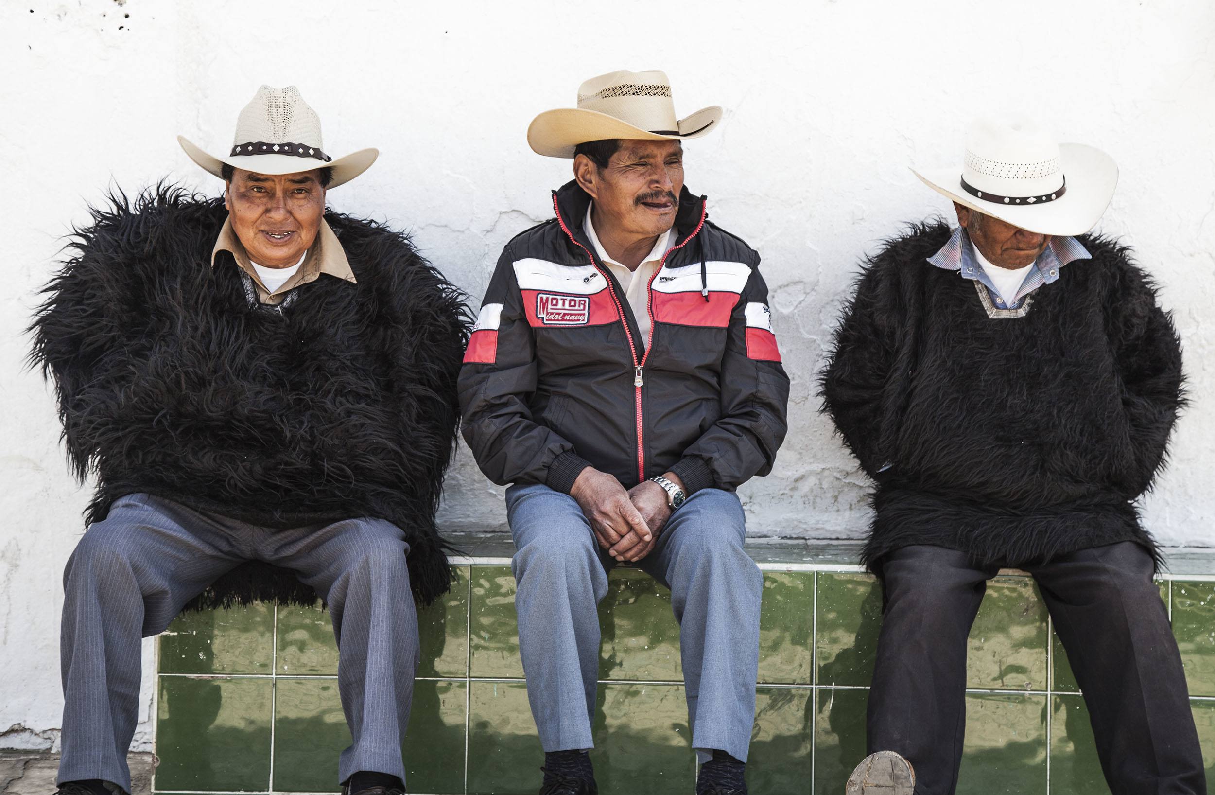 Tzotzil men sitting outside Iglesia de San Juan in San Juan Chamula Mexico