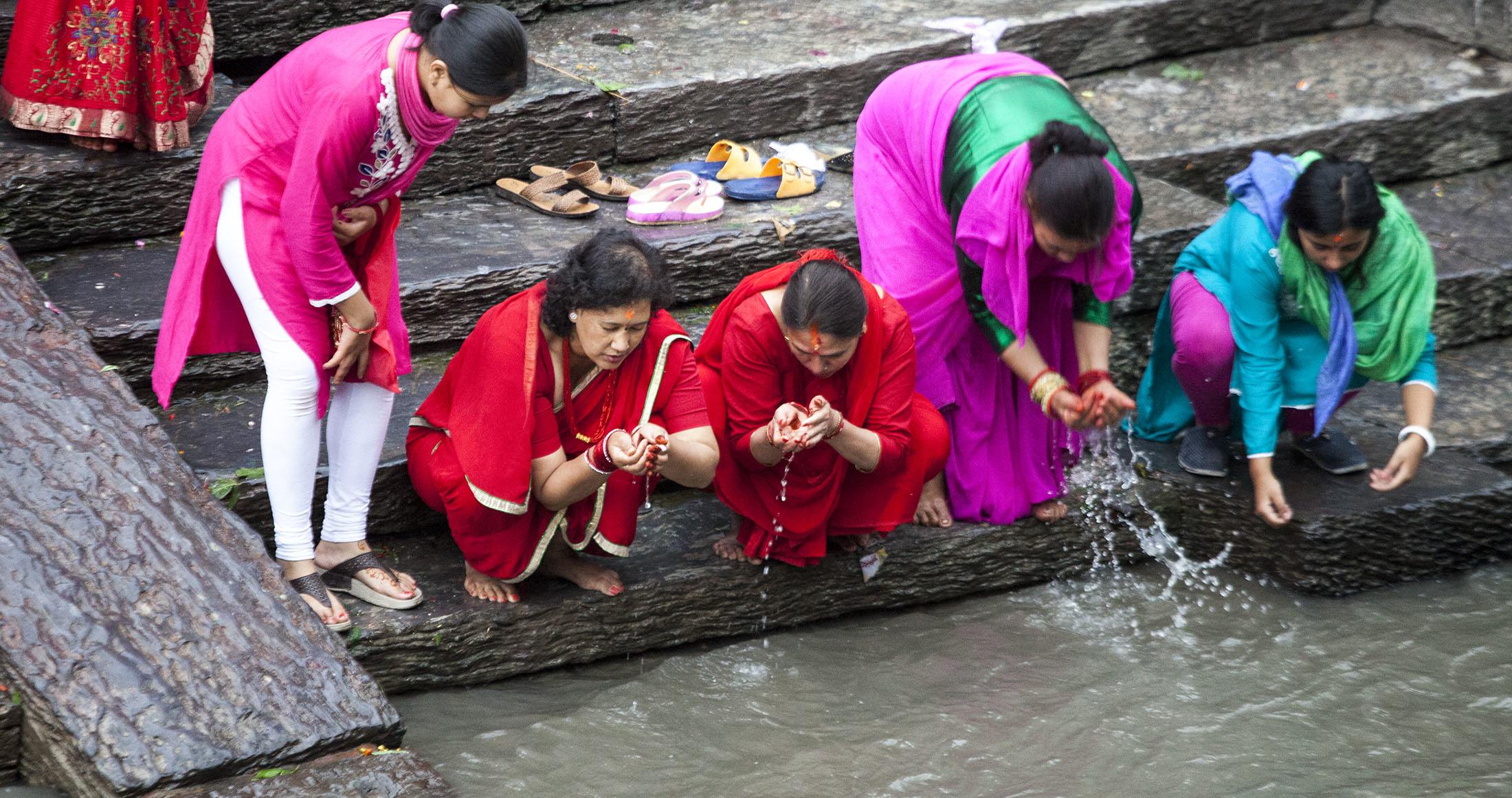 Women at the river running beside Pashupatinath Temple in Kathmandu Nepal