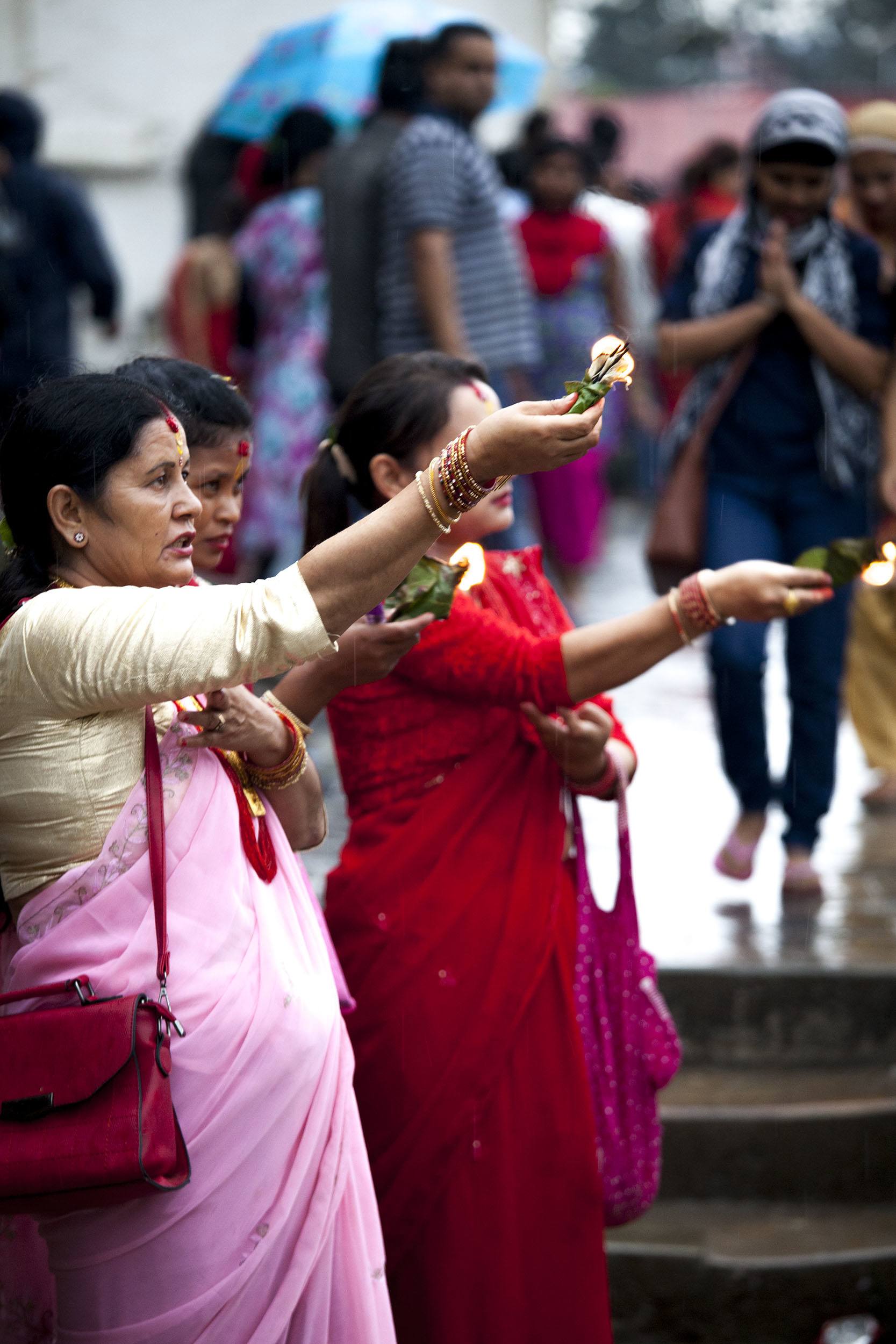 Women holding candles in direction of temple during Teej in Kathmandu Nepal