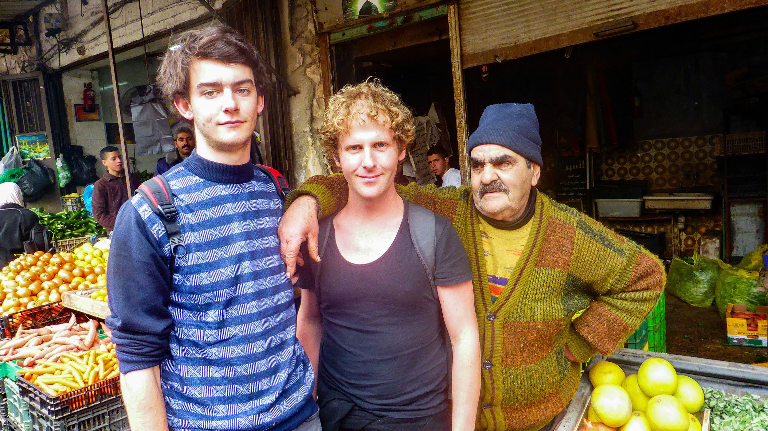 Ben with other traveller and Palestinian man at a market in Nablus