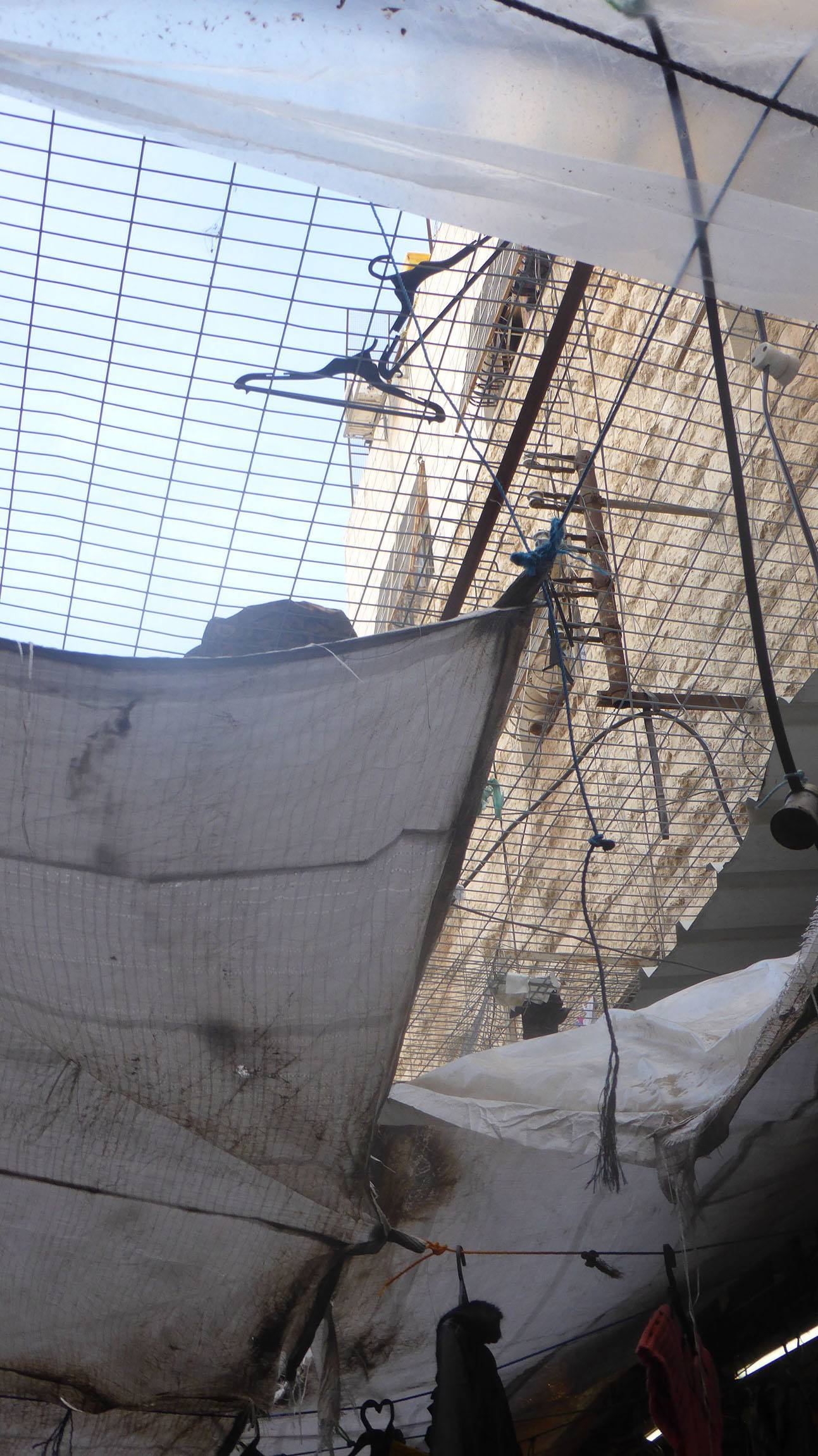 Wire caging separating people in street in Hebron Palestine