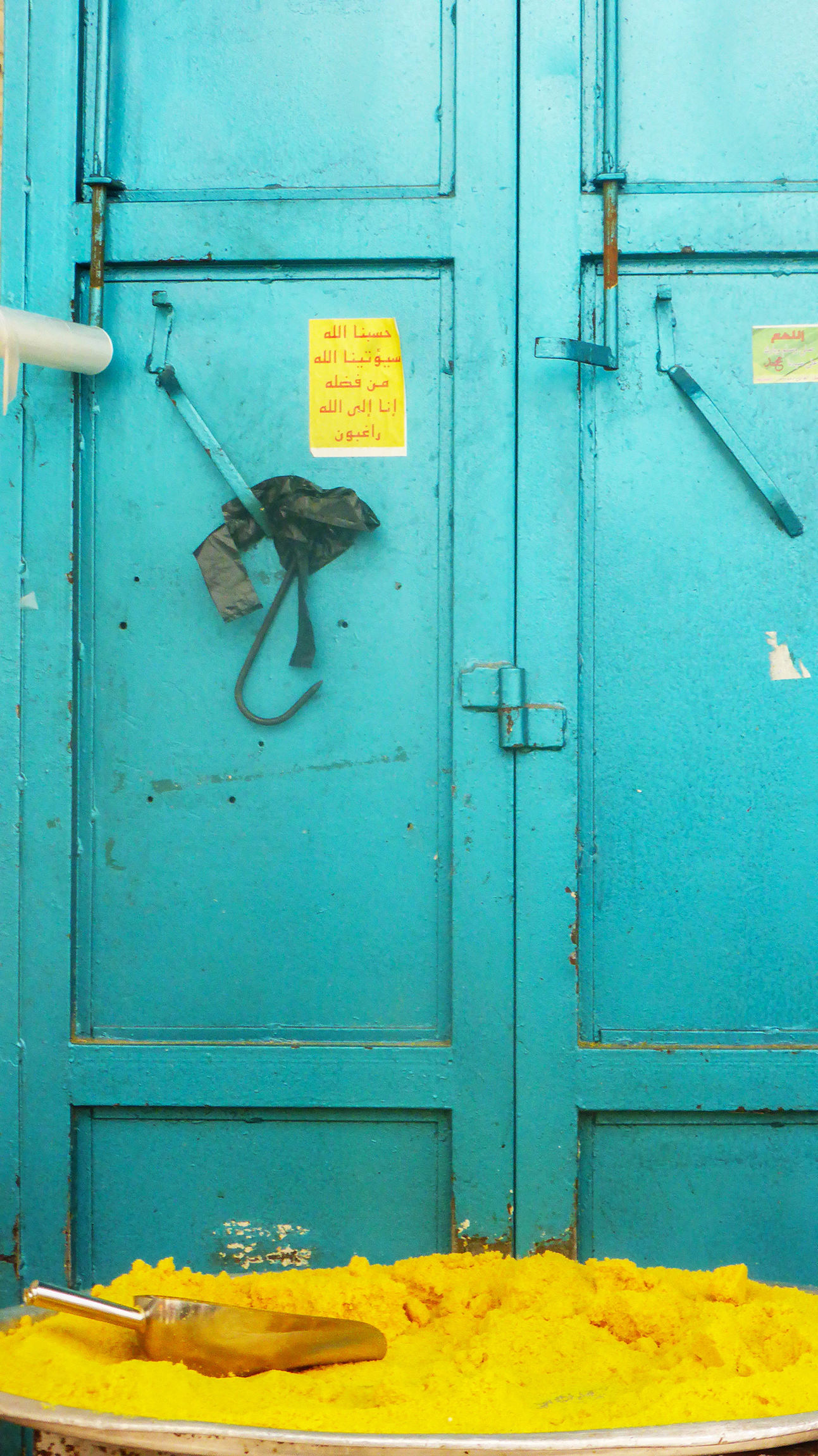 Yellow spice in front of blue door in Nablus Palestine