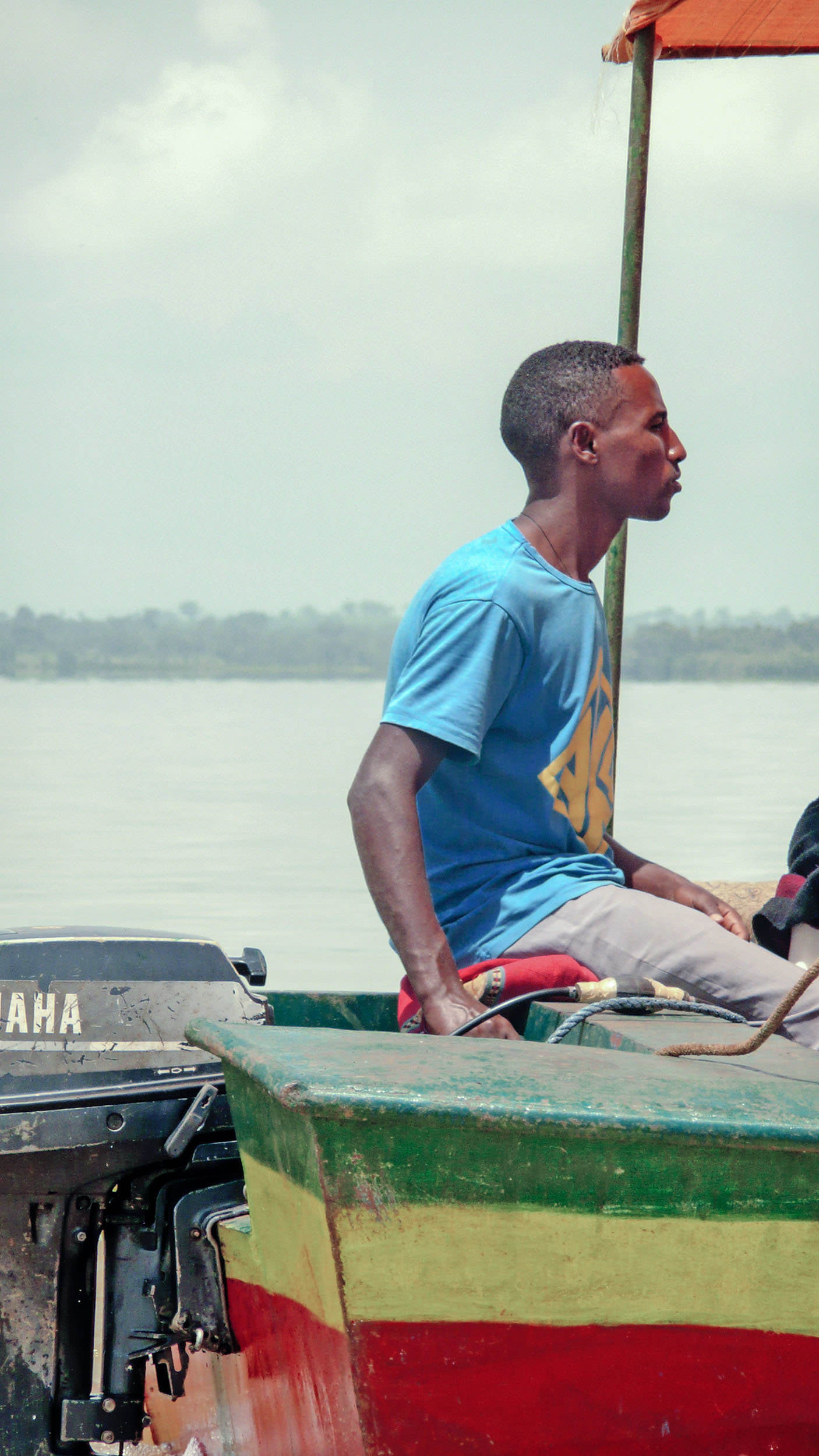 An Ethiopian man steering a boat around Lake Tana in Bahir Dar Ethiopia