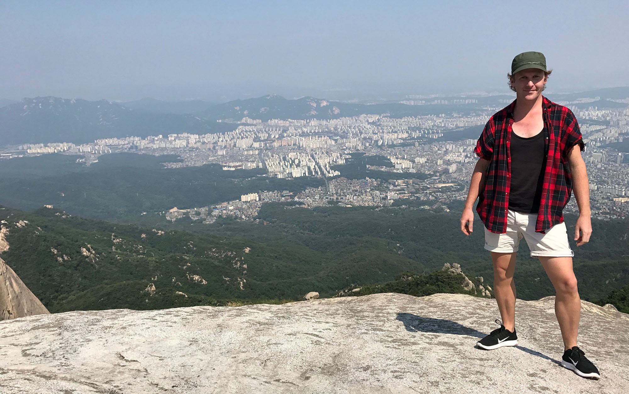 Ben standing on top of Bukhansan Mountain in Seoul Republic of Korea