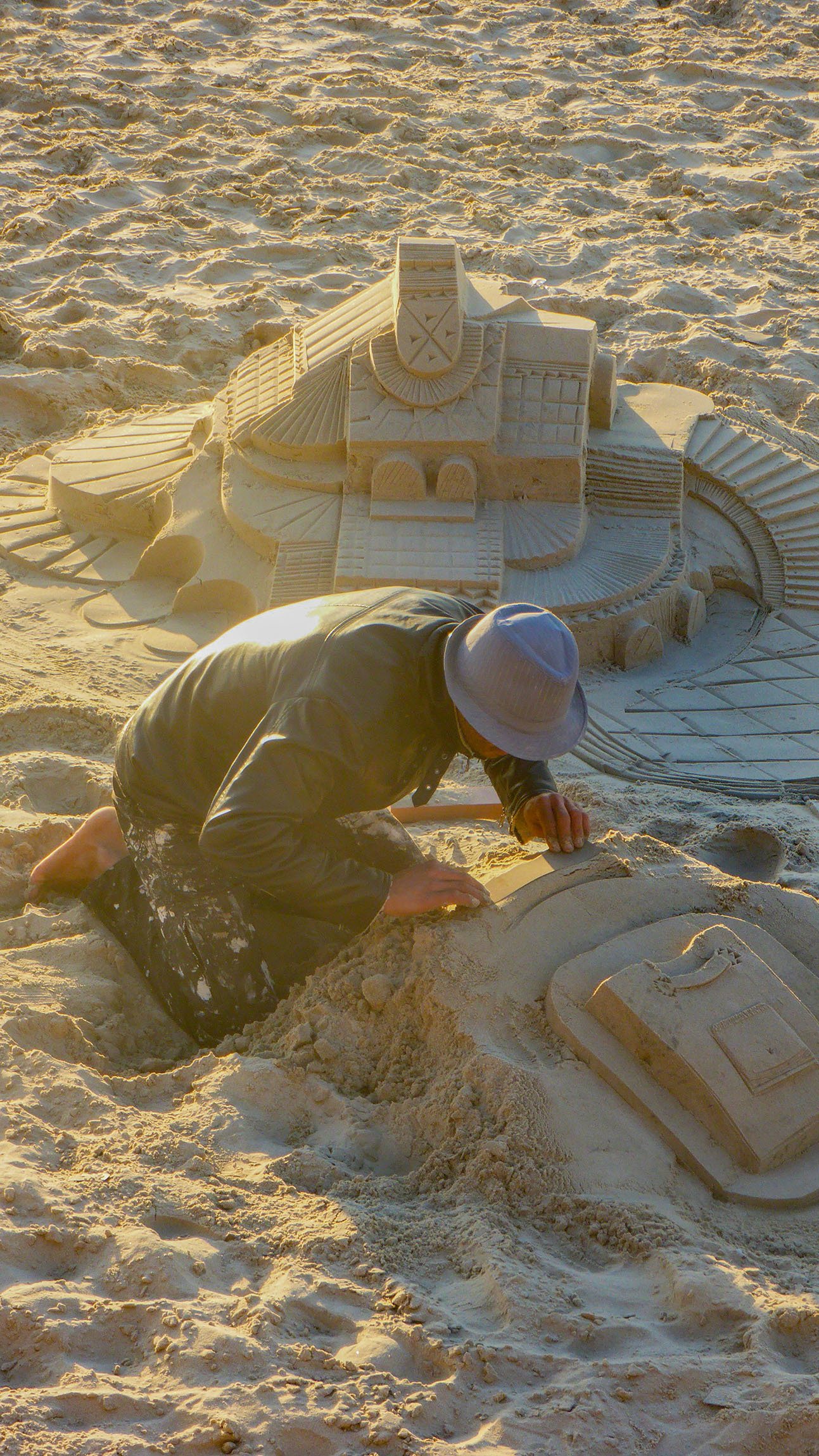 Man creating sand sculptures on a beach in Tel Aviv Israel