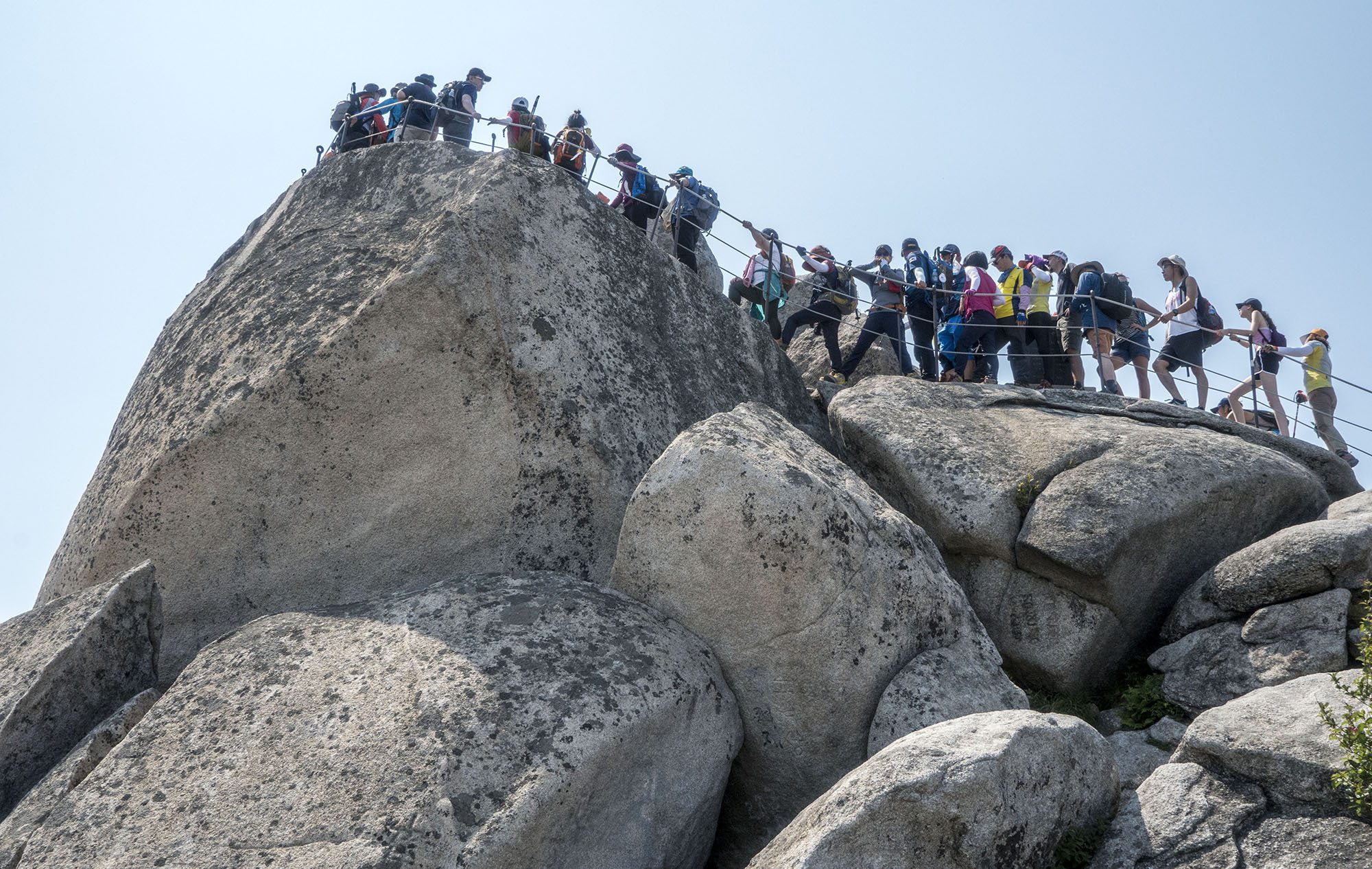 People trekking to the summit of Bukhansan Mountain in Seoul Republic of Korea