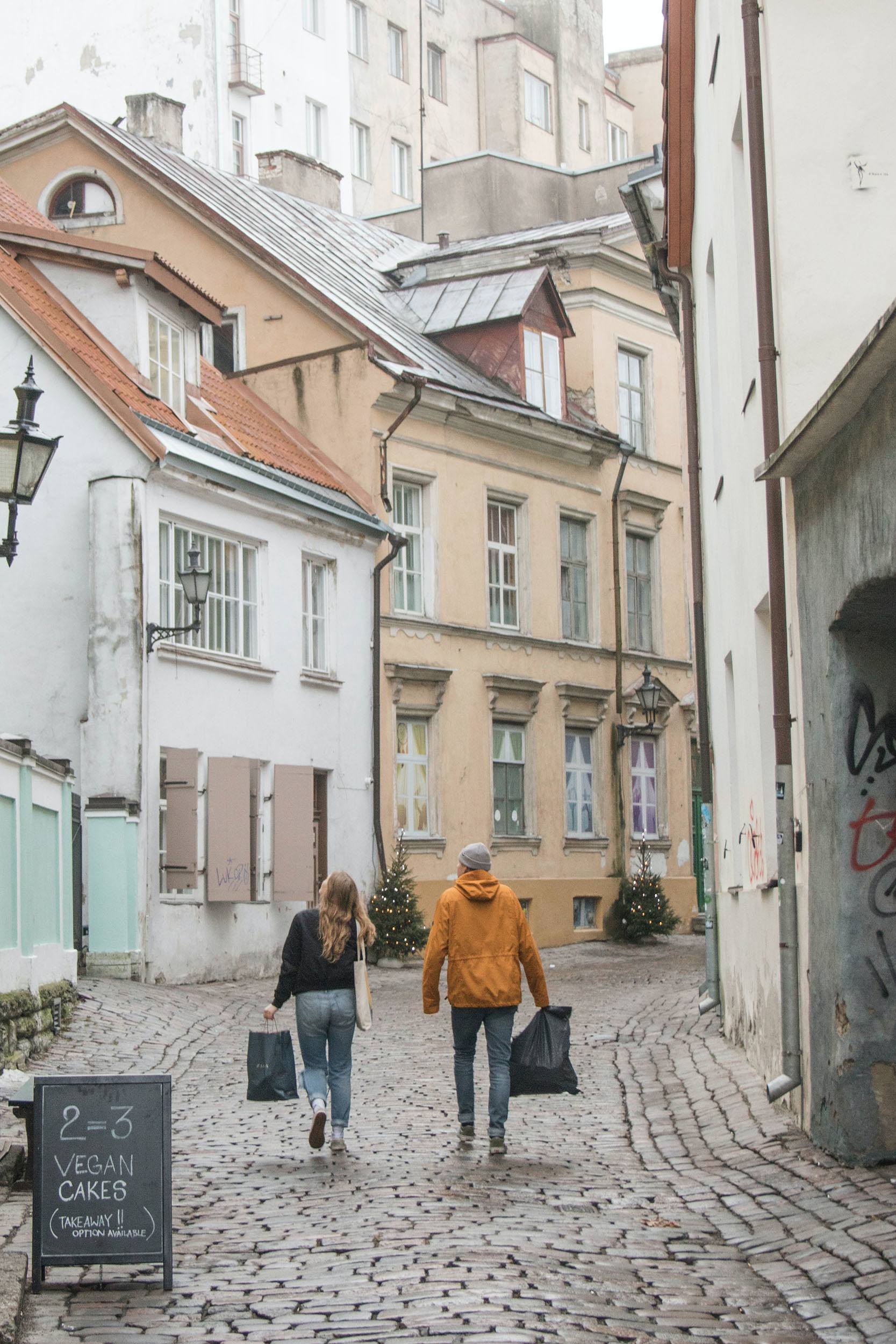 People walking through the cobblestone streets of Tallinn Estonia