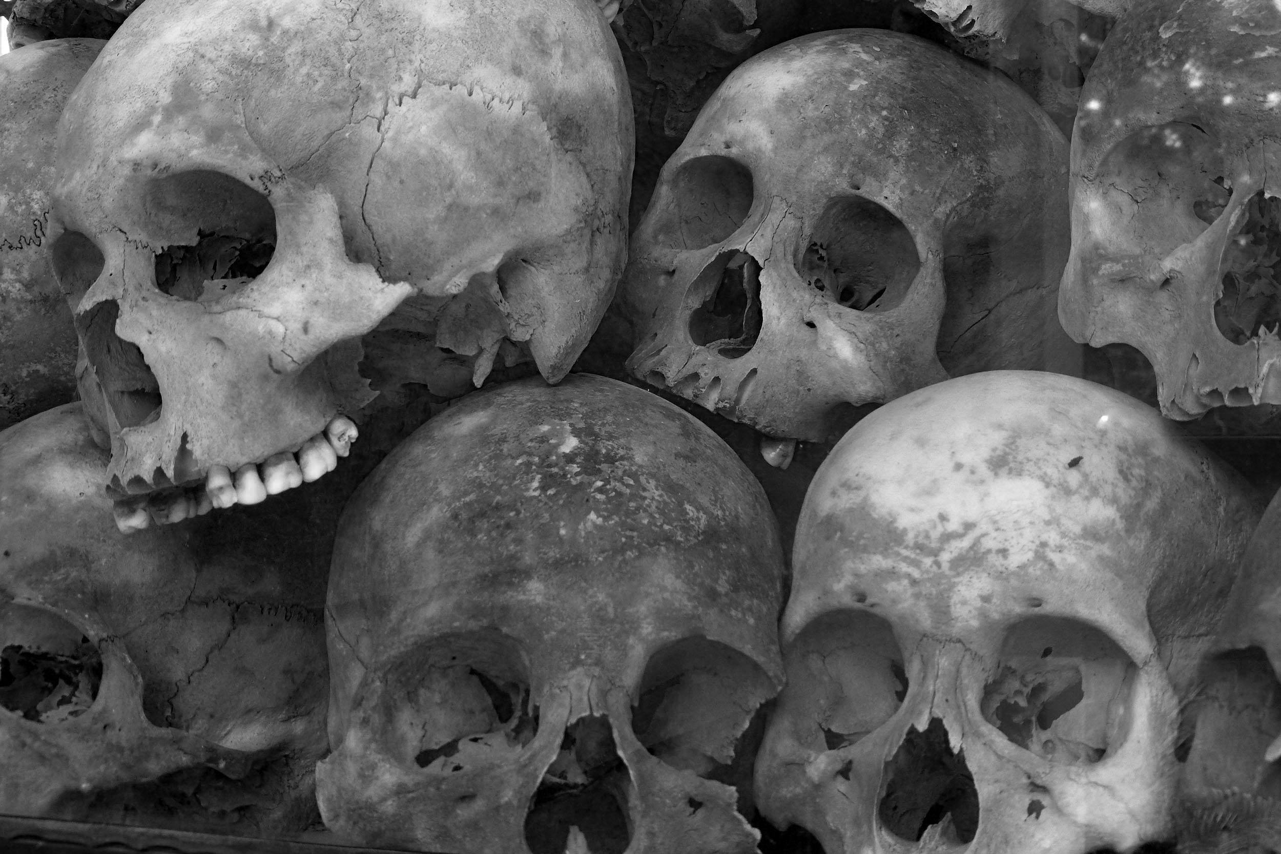 Skulls in glass case at the Killing Fields near Phnom Penh Cambodia