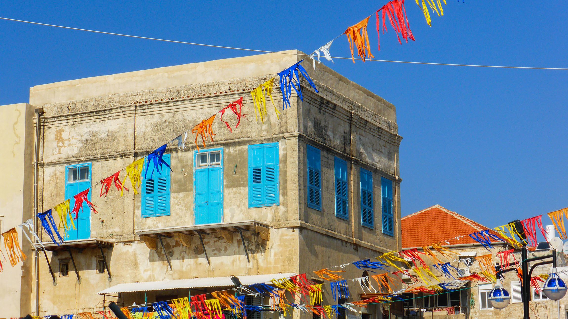 Square concrete building with blue trimmings in Akko Israel